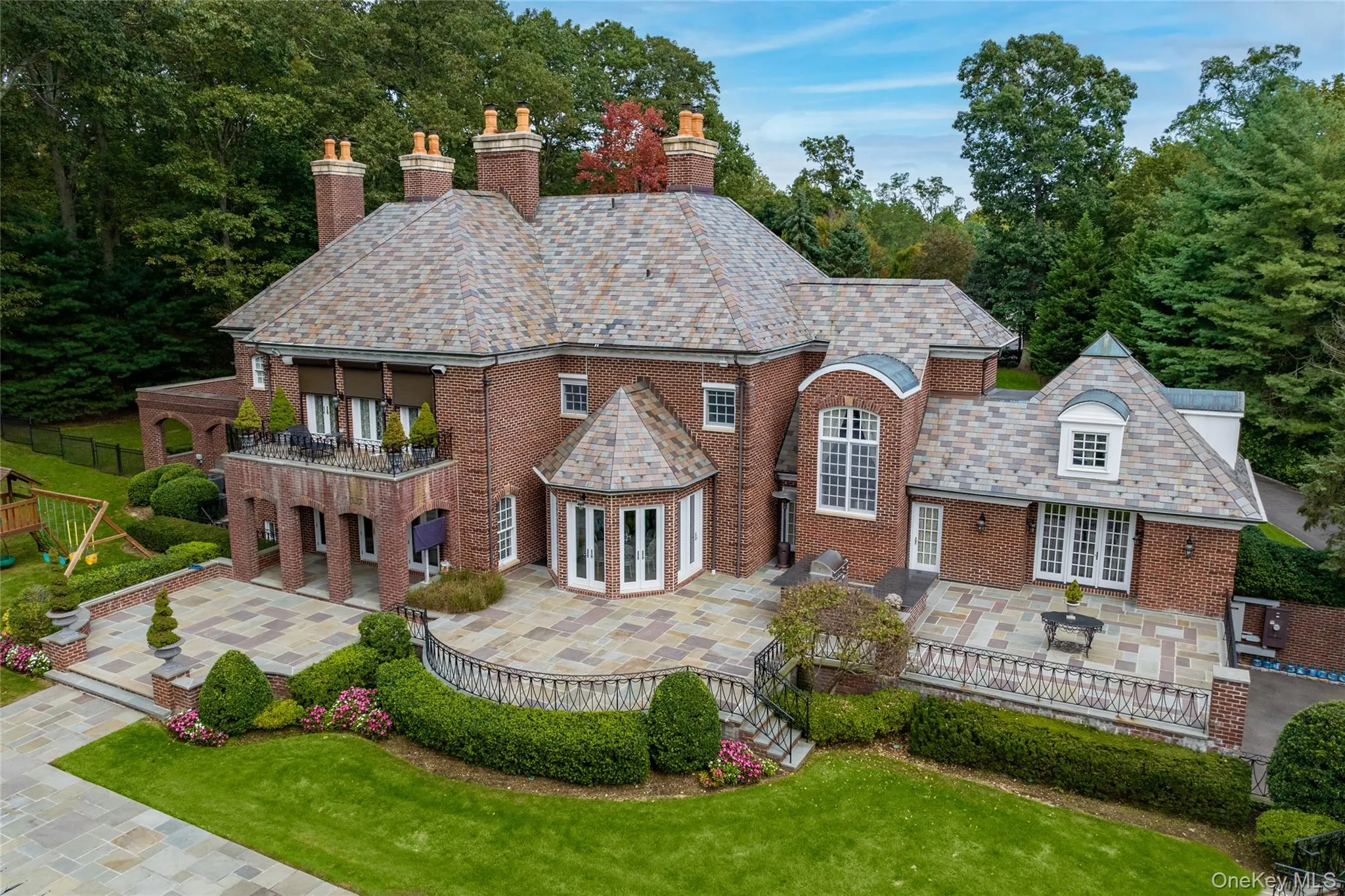 Back view of Mansion with built-in BBQ & kitchen, slate roof, copper gutters & leaders Back view of Mansion with built-in BBQ & kitchen, slate roof, copper gutters & leaders