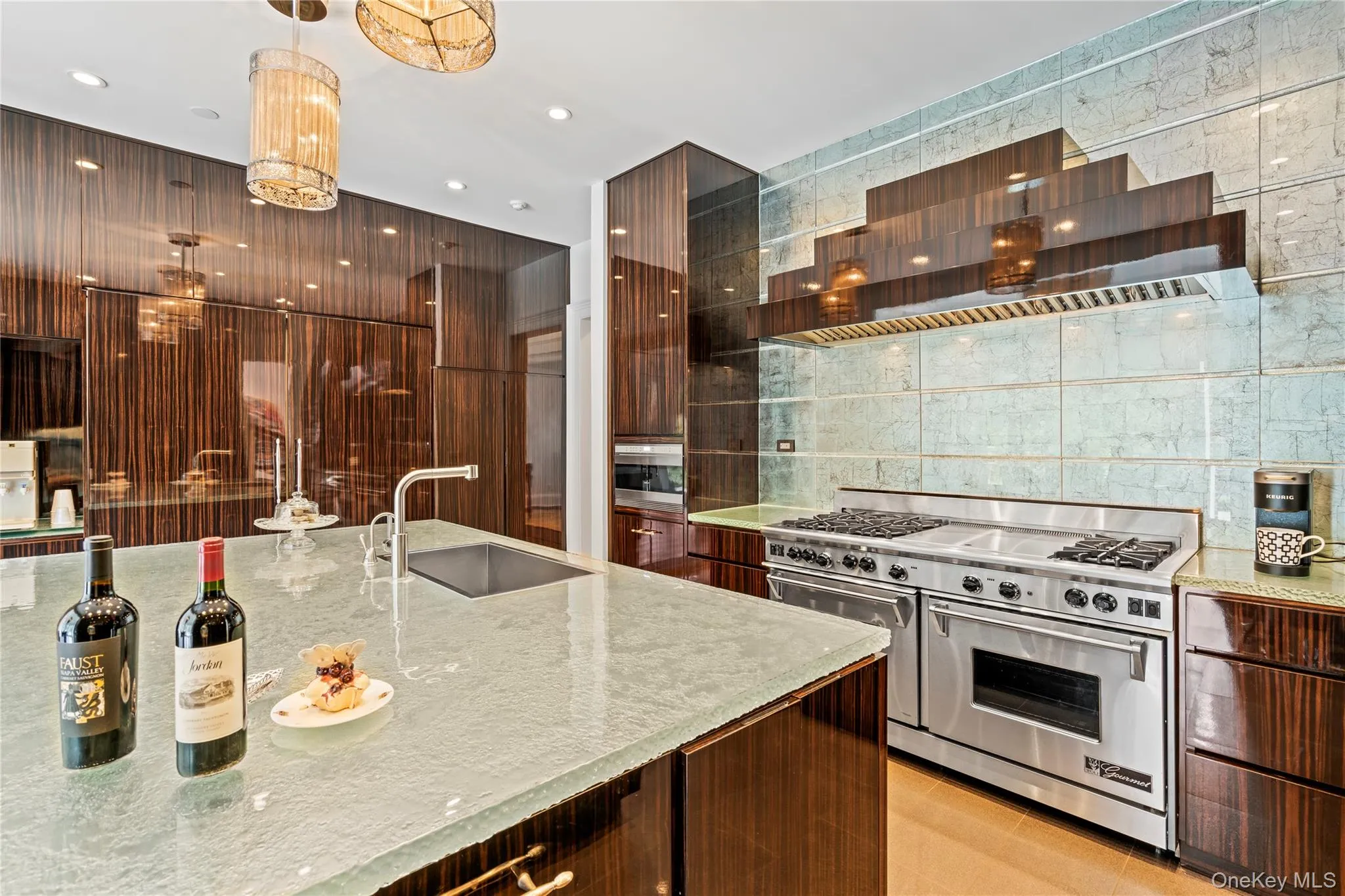 Illuminating glass counter tops and backsplash makes a statement in this custom kitchen Illuminating glass counter tops and backsplash makes a statement in this custom kitchen