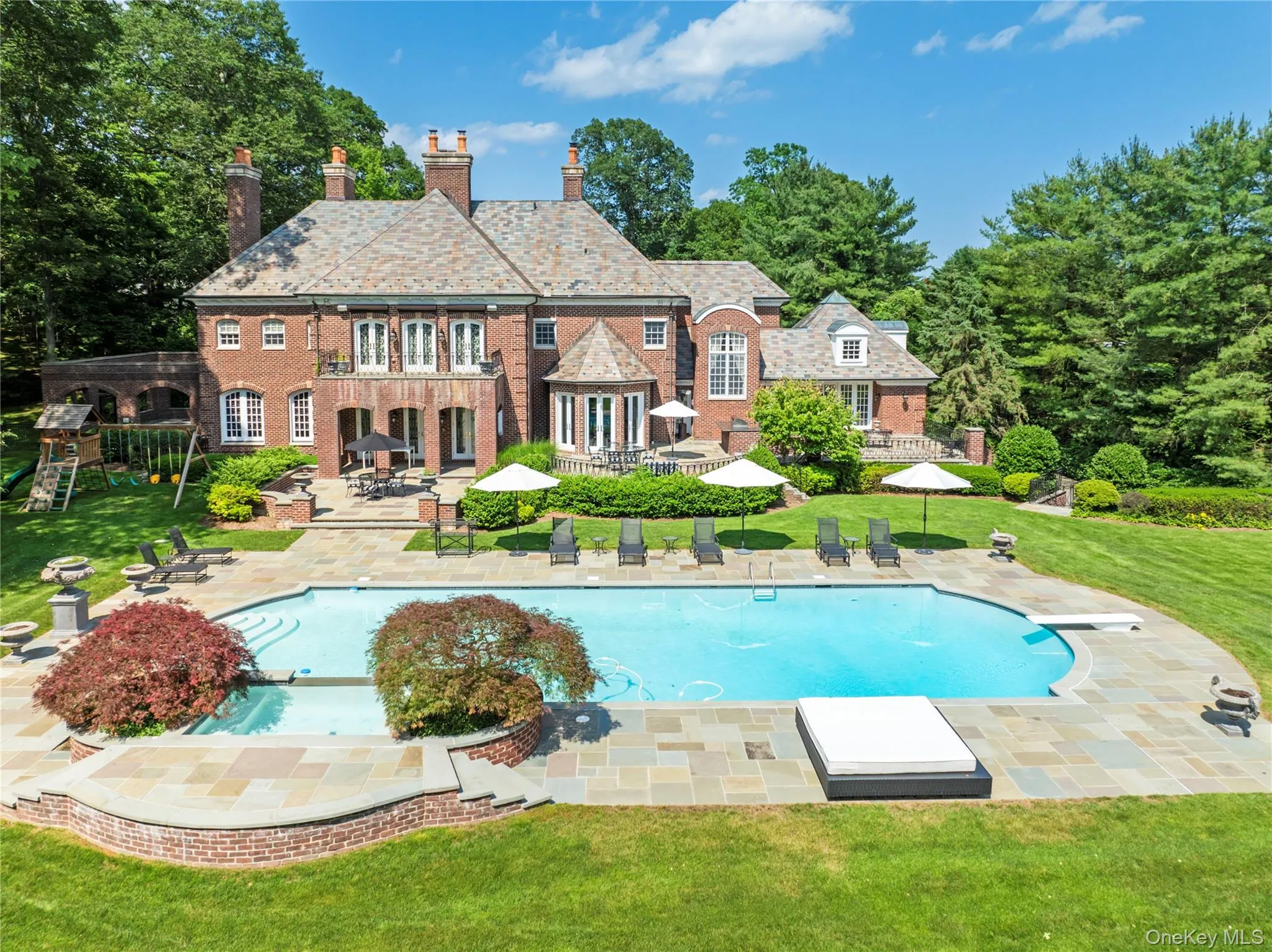 Bluestone patios extend to surround 50' Pool with Hot Tub/waterfall Bluestone patios extend to surround 50' Pool with Hot Tub/waterfall