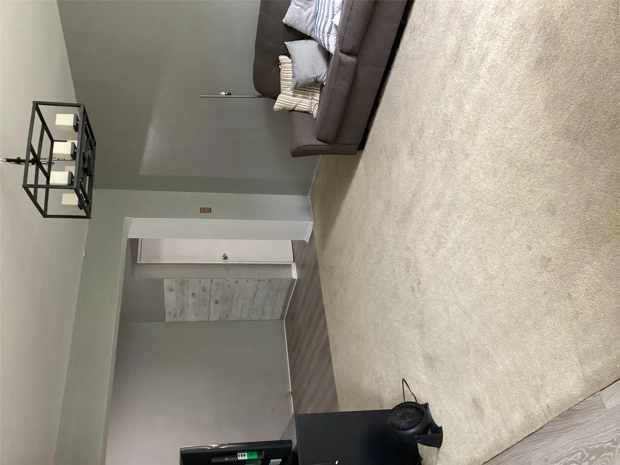 Living area featuring dark carpet and a chandelier Living area featuring dark carpet and a chandelier