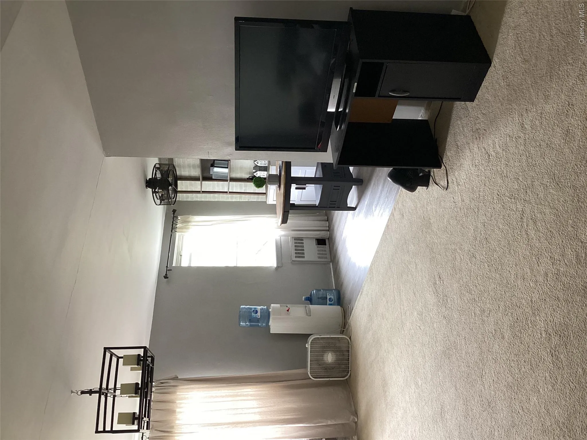 Carpeted home office with a chandelier and radiator Carpeted home office with a chandelier and radiator
