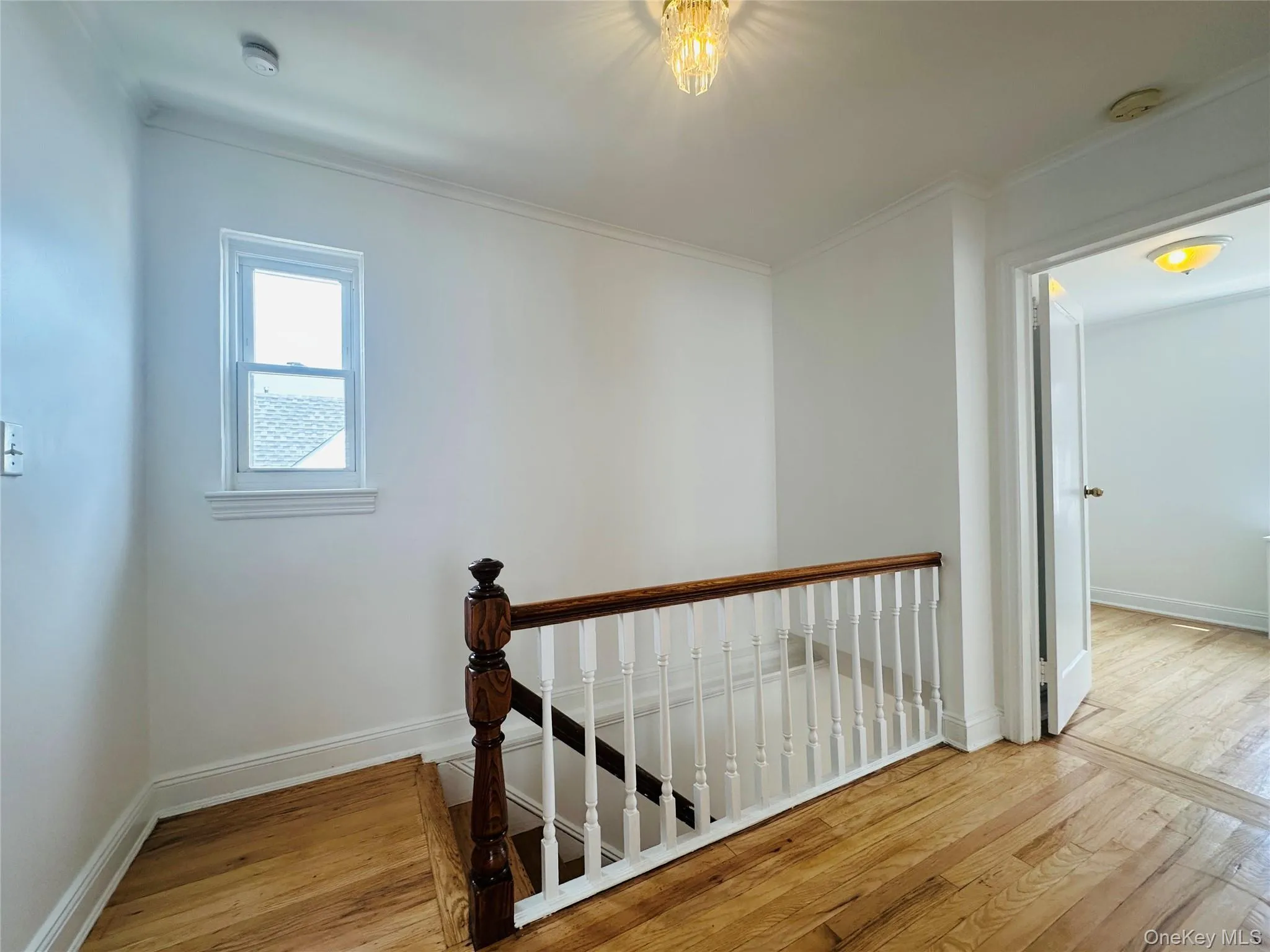 Staircase with wood finished floors and crown molding Staircase with wood finished floors and crown molding