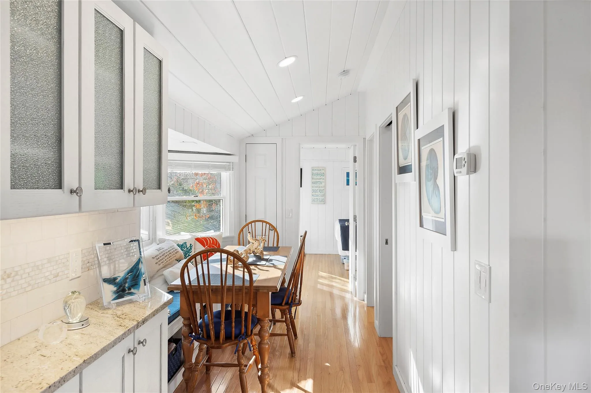 Dining room with vaulted ceiling, light wood-type flooring, and recessed lighting Dining room with vaulted ceiling, light wood-type flooring, and recessed lighting