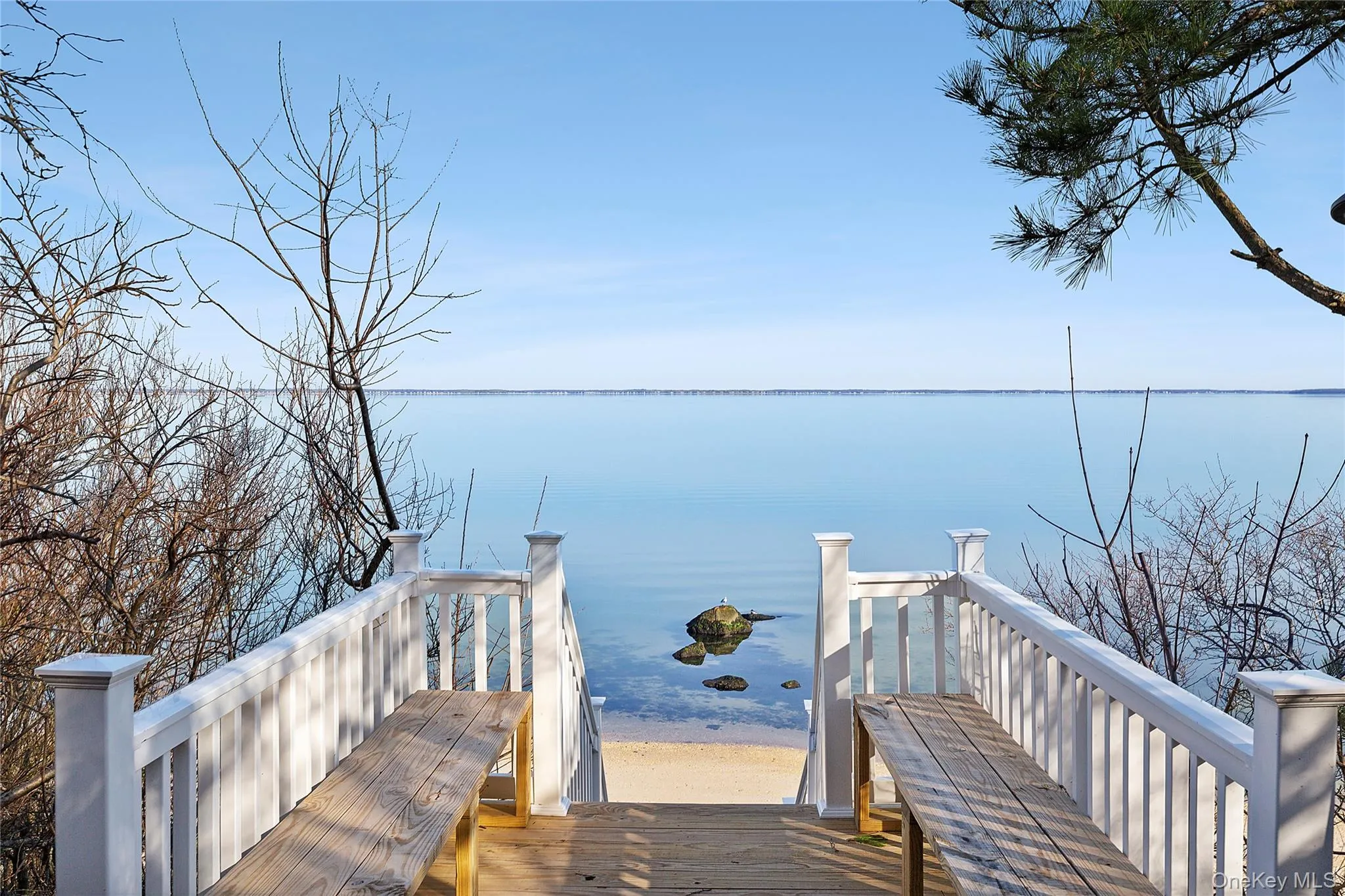 View of home's community featuring a deck with water view View of home's community featuring a deck with water view