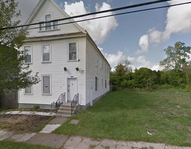 View of front of home with a front lawn and entry steps