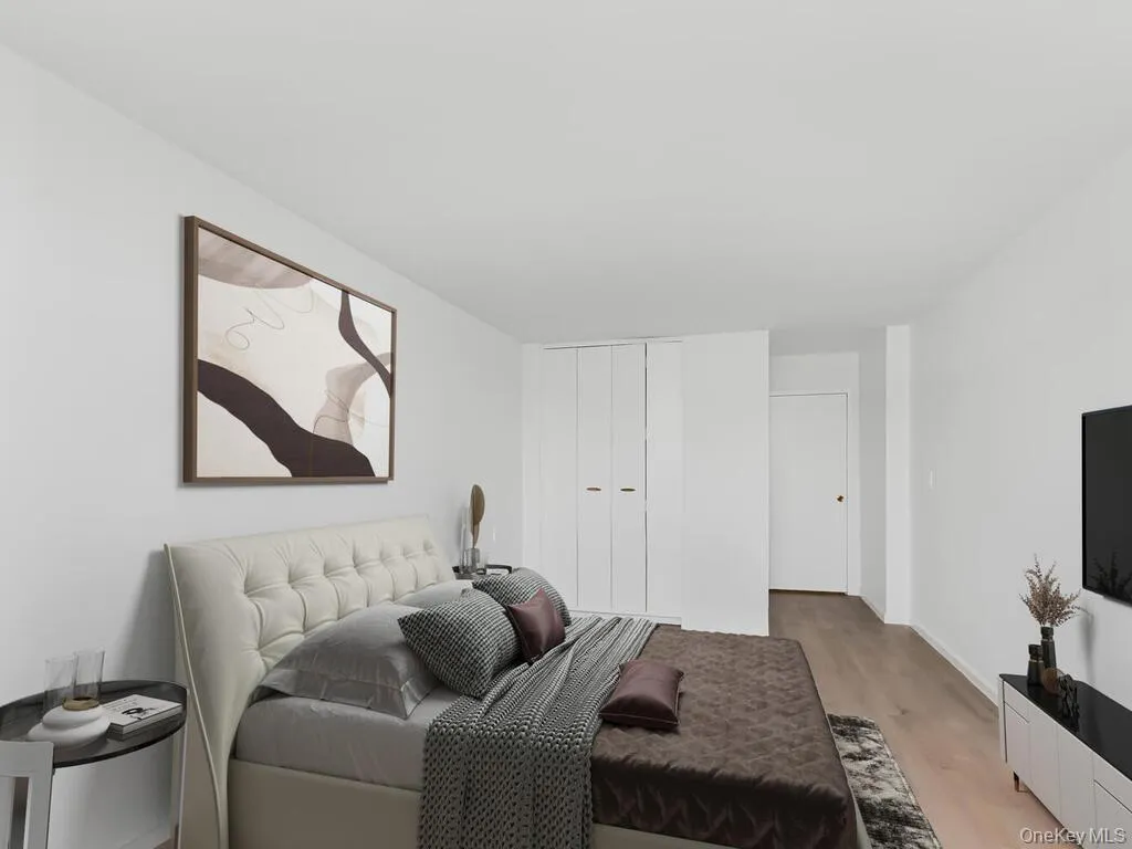 Bedroom with light wood-type flooring and a closet Bedroom with light wood-type flooring and a closet
