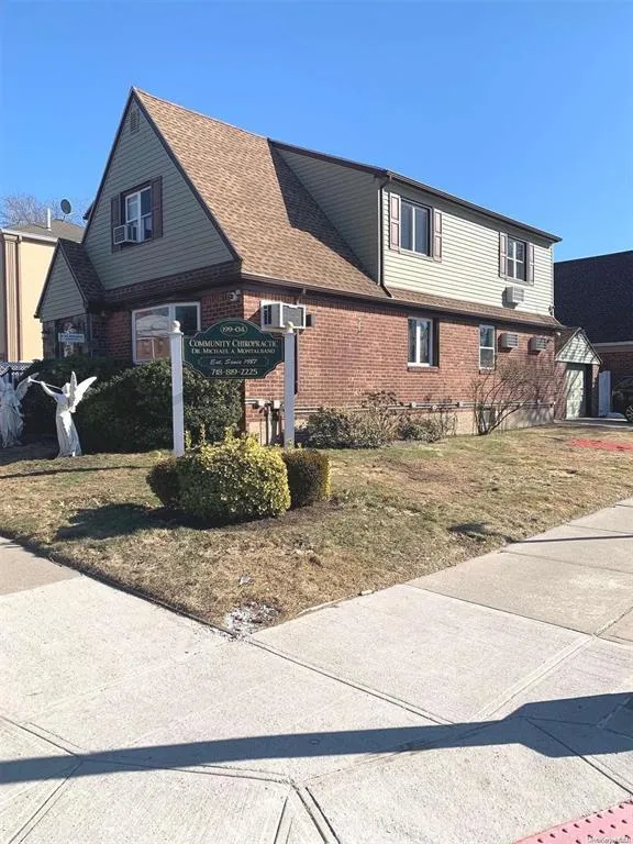 View of side of home with brick siding and roof with shingles View of side of home with brick siding and roof with shingles
