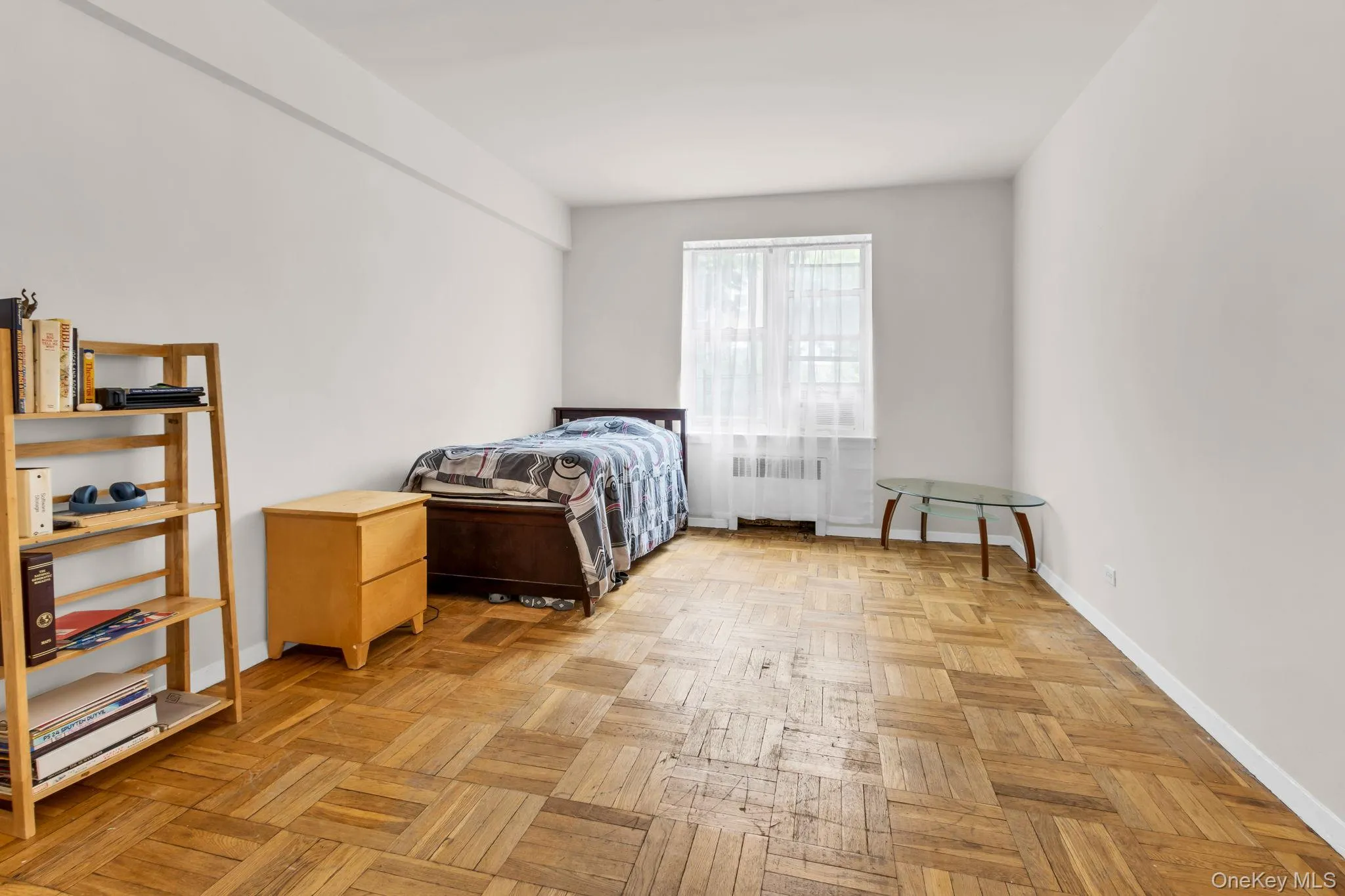 Bedroom with radiator heating unit and baseboards Bedroom with radiator heating unit and baseboards