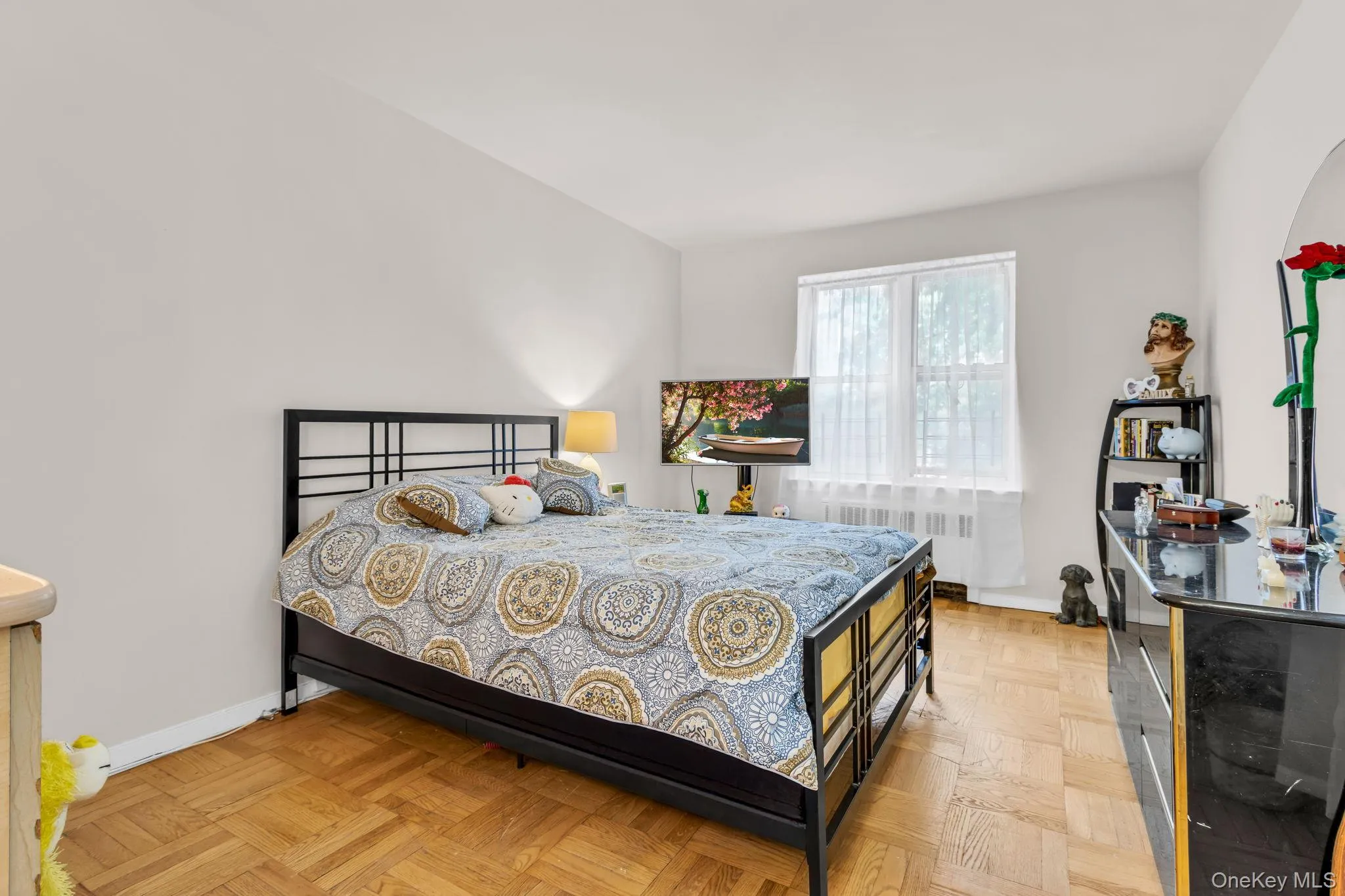 Bedroom with radiator and baseboards Bedroom with radiator and baseboards