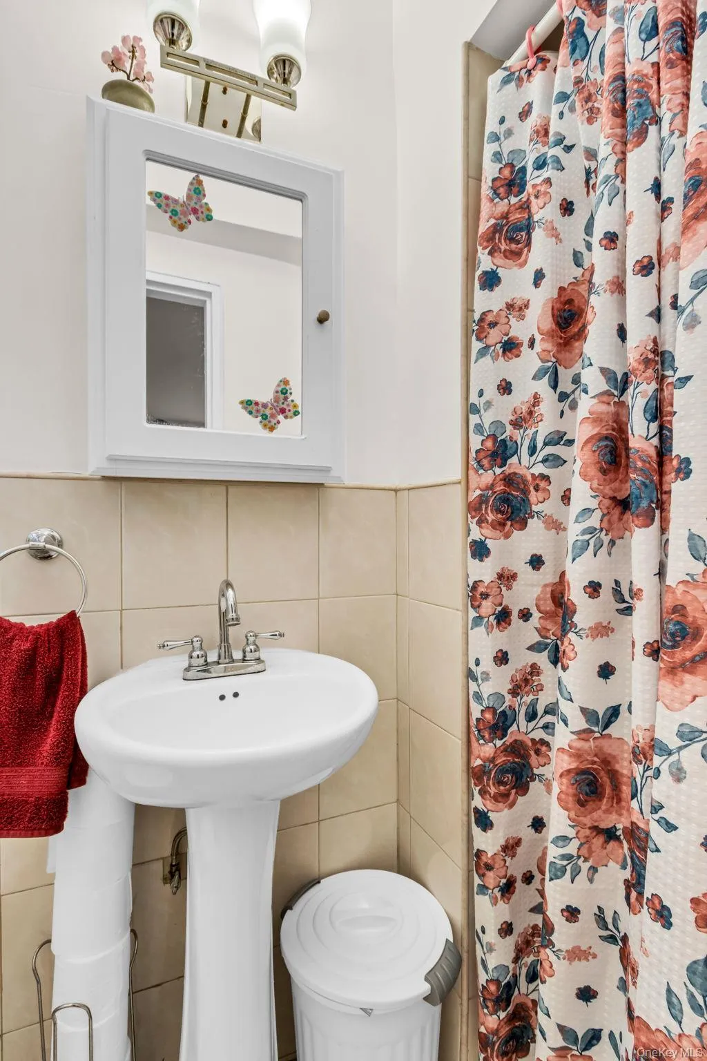 Bathroom with tile walls, a shower with shower curtain, and decorative backsplash Bathroom with tile walls, a shower with shower curtain, and decorative backsplash