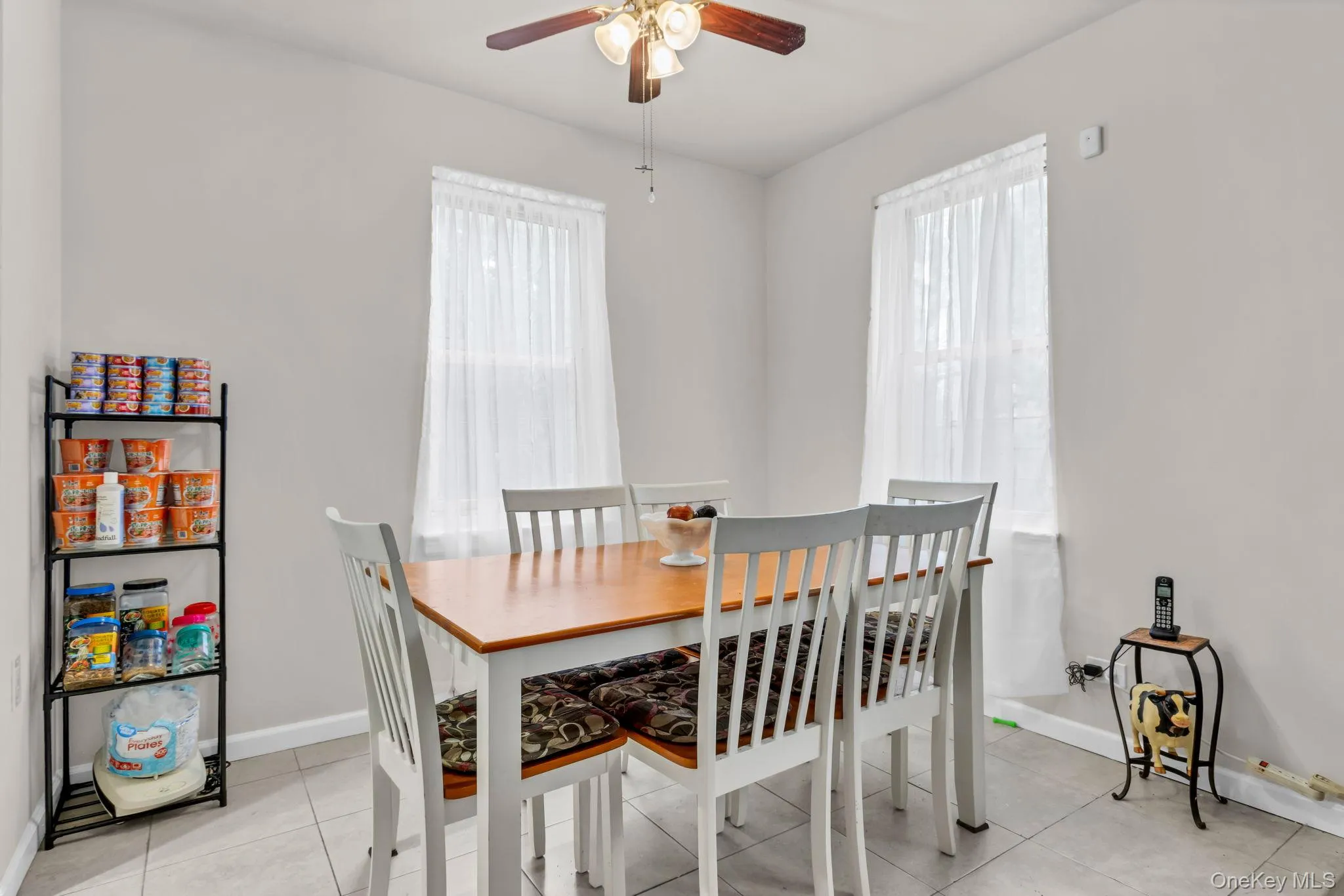 Dining space with healthy amount of natural light, a ceiling fan, and baseboards Dining space with healthy amount of natural light, a ceiling fan, and baseboards