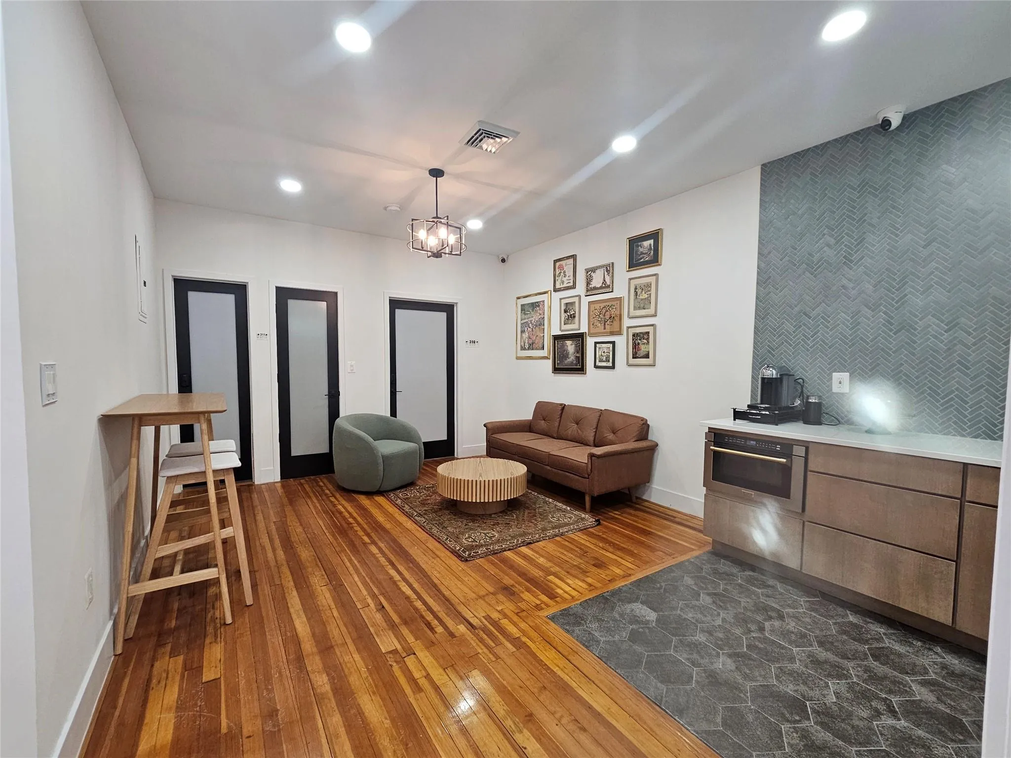 Living area with dark wood finished floors, baseboards, and recessed lighting Living area with dark wood finished floors, baseboards, and recessed lighting
