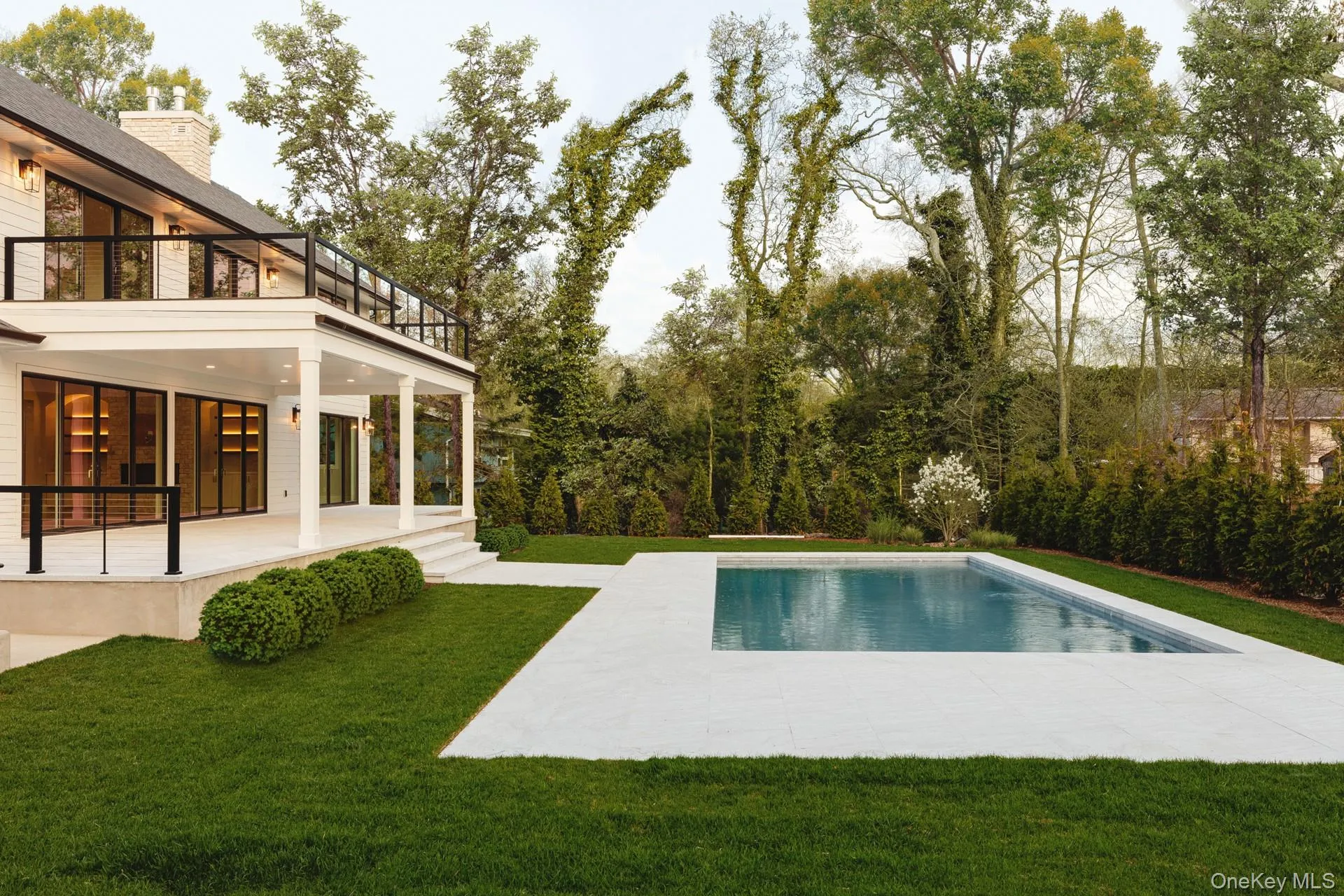 Outdoor pool featuring a patio area and a yard Outdoor pool featuring a patio area and a yard