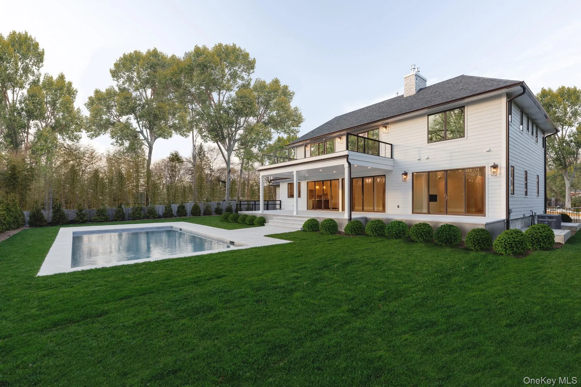 Rear view of property featuring a balcony, a chimney, central air condition unit, and a patio Rear view of property featuring a balcony, a chimney, central air condition unit, and a patio