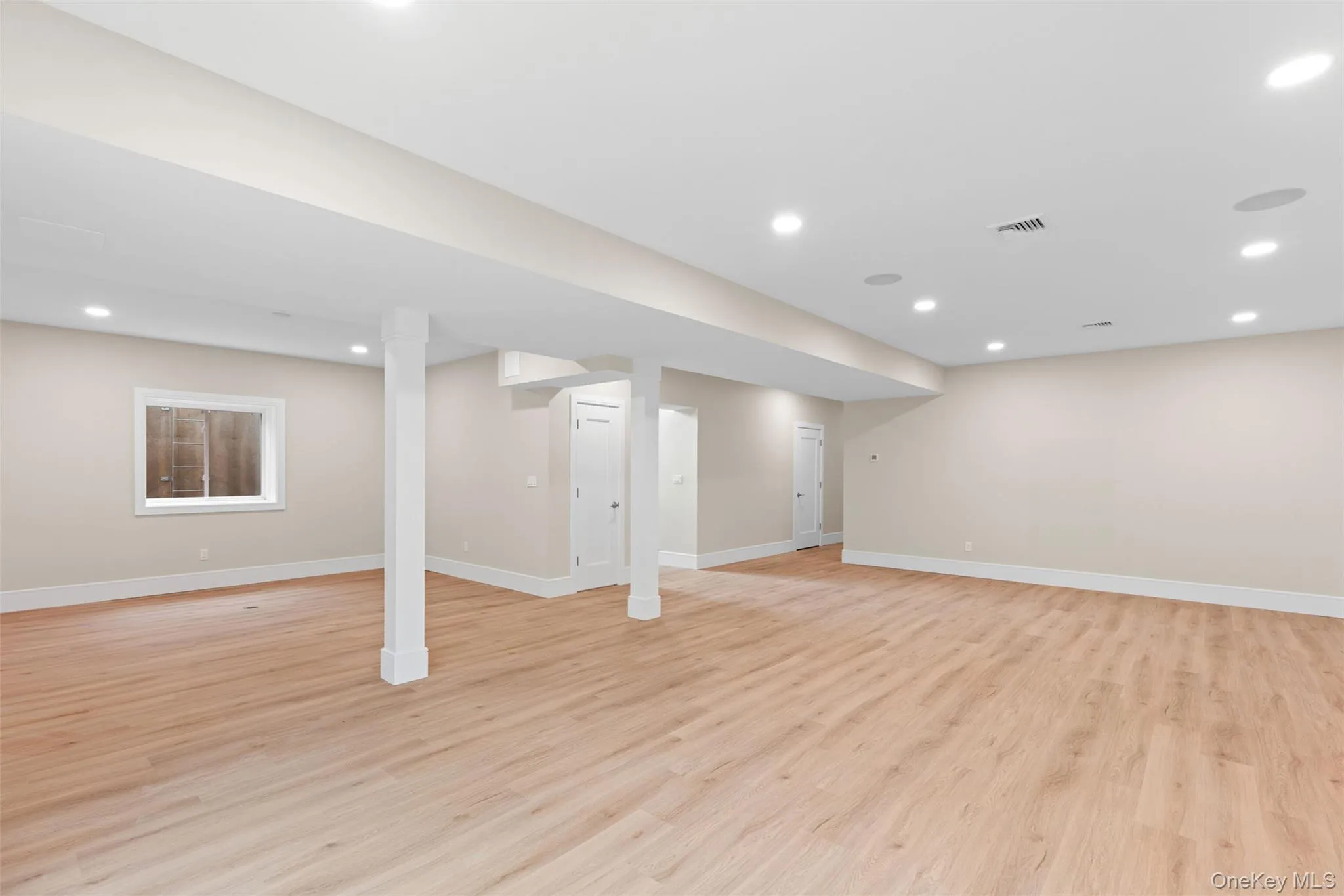 Finished below grade area featuring light wood-style flooring, baseboards, and recessed lighting Finished below grade area featuring light wood-style flooring, baseboards, and recessed lighting