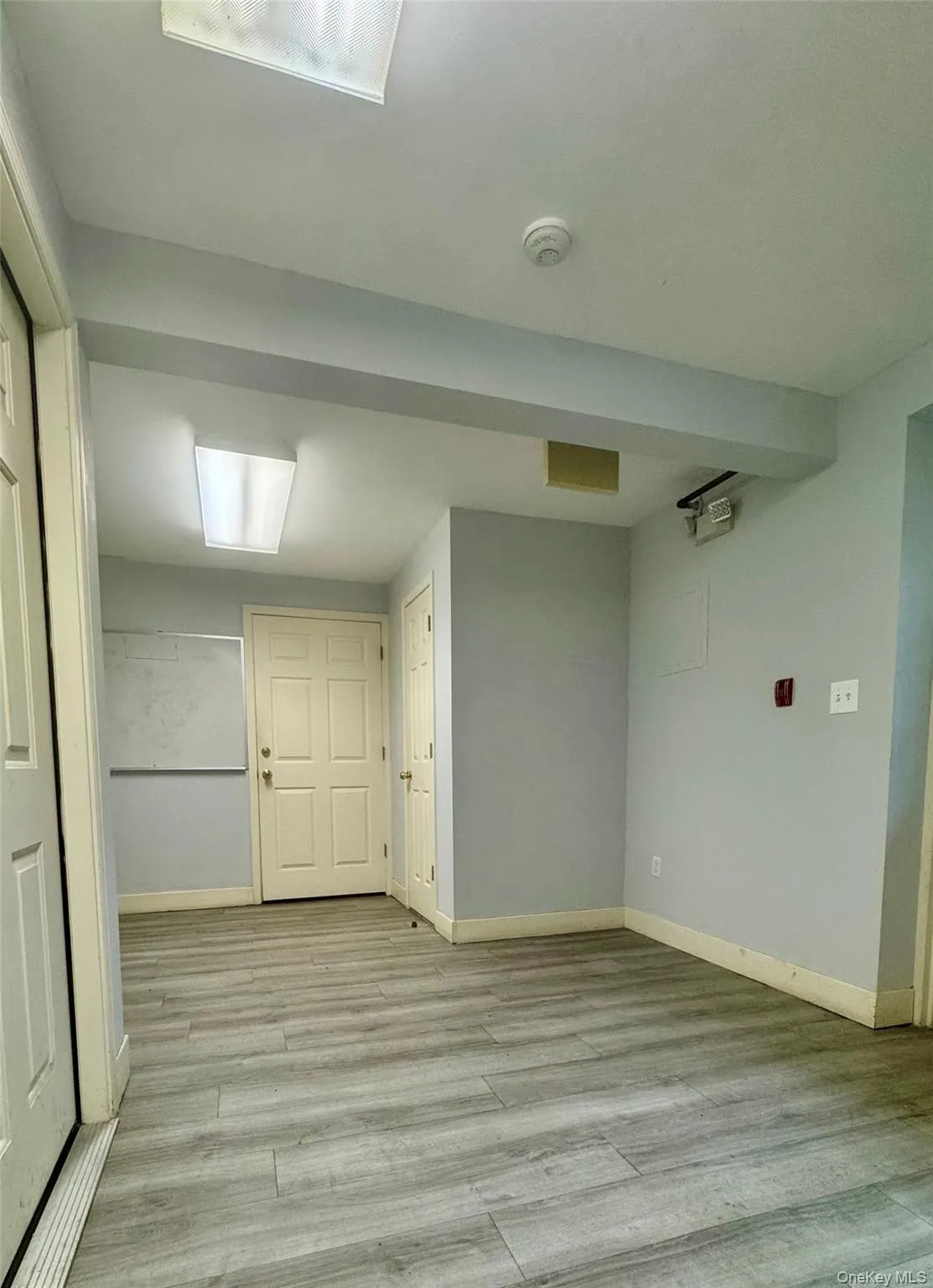 Below grade area featuring light wood finished floors and baseboards Below grade area featuring light wood finished floors and baseboards
