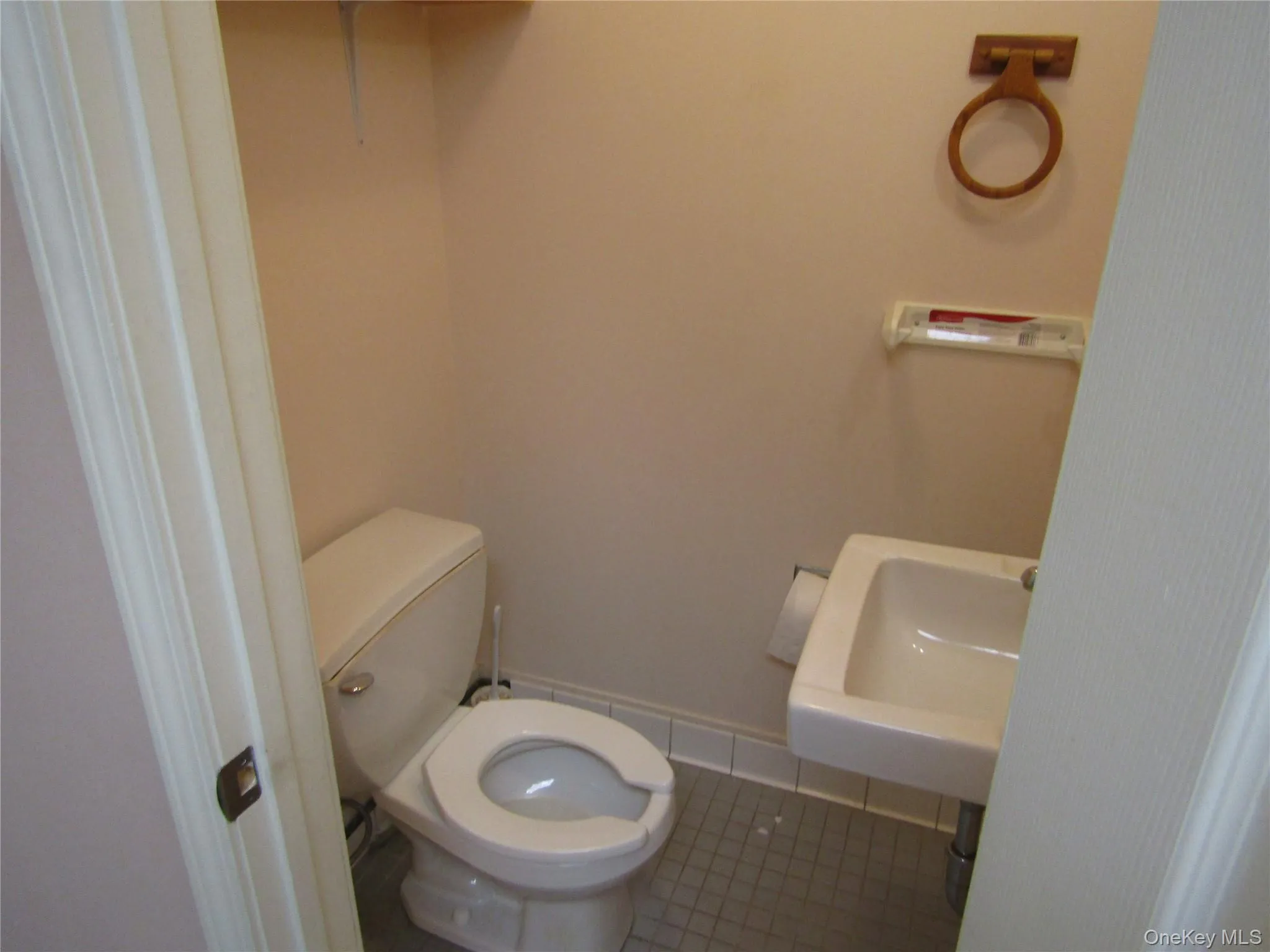 Bathroom featuring tile patterned flooring, toilet, and sink Bathroom featuring tile patterned flooring, toilet, and sink