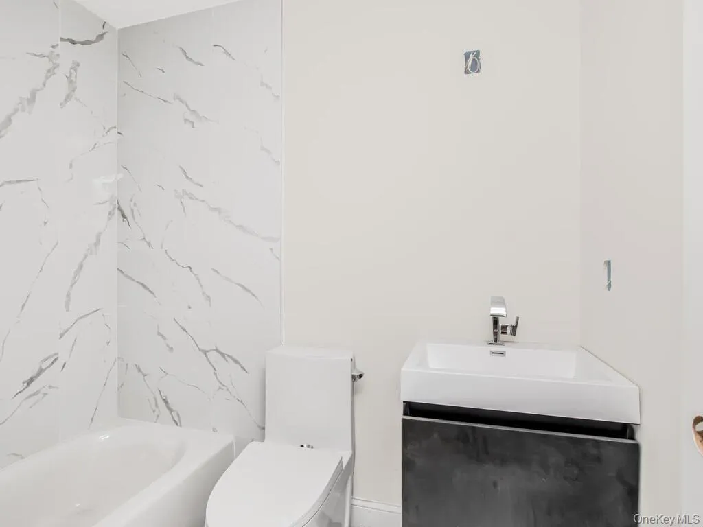 Full bathroom with toilet and a sink Full bathroom with toilet and a sink