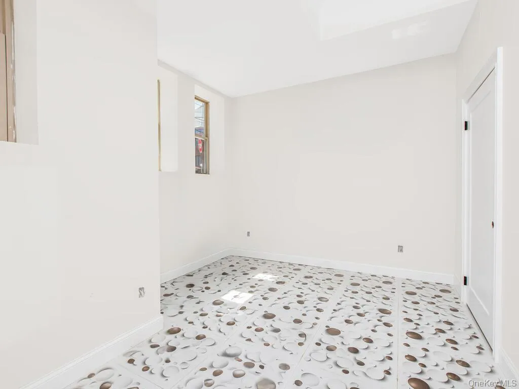 Unfurnished room with baseboards Unfurnished room with baseboards