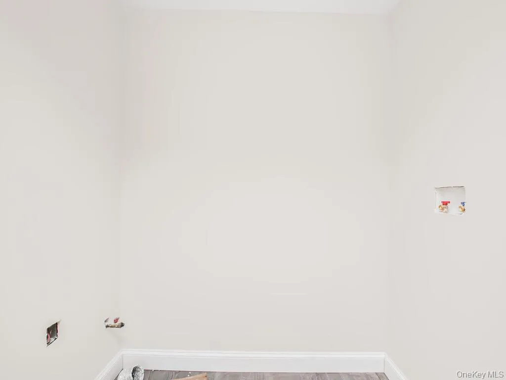 Clothes washing area featuring washer hookup, baseboards, hookup for a gas dryer, and light wood-style flooring Clothes washing area featuring washer hookup, baseboards, hookup for a gas dryer, and light wood-style flooring