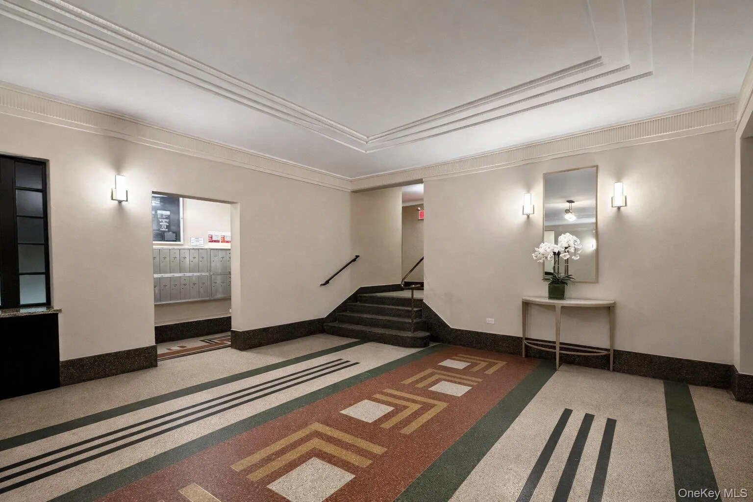 Community lobby featuring stairs and crown molding Community lobby featuring stairs and crown molding