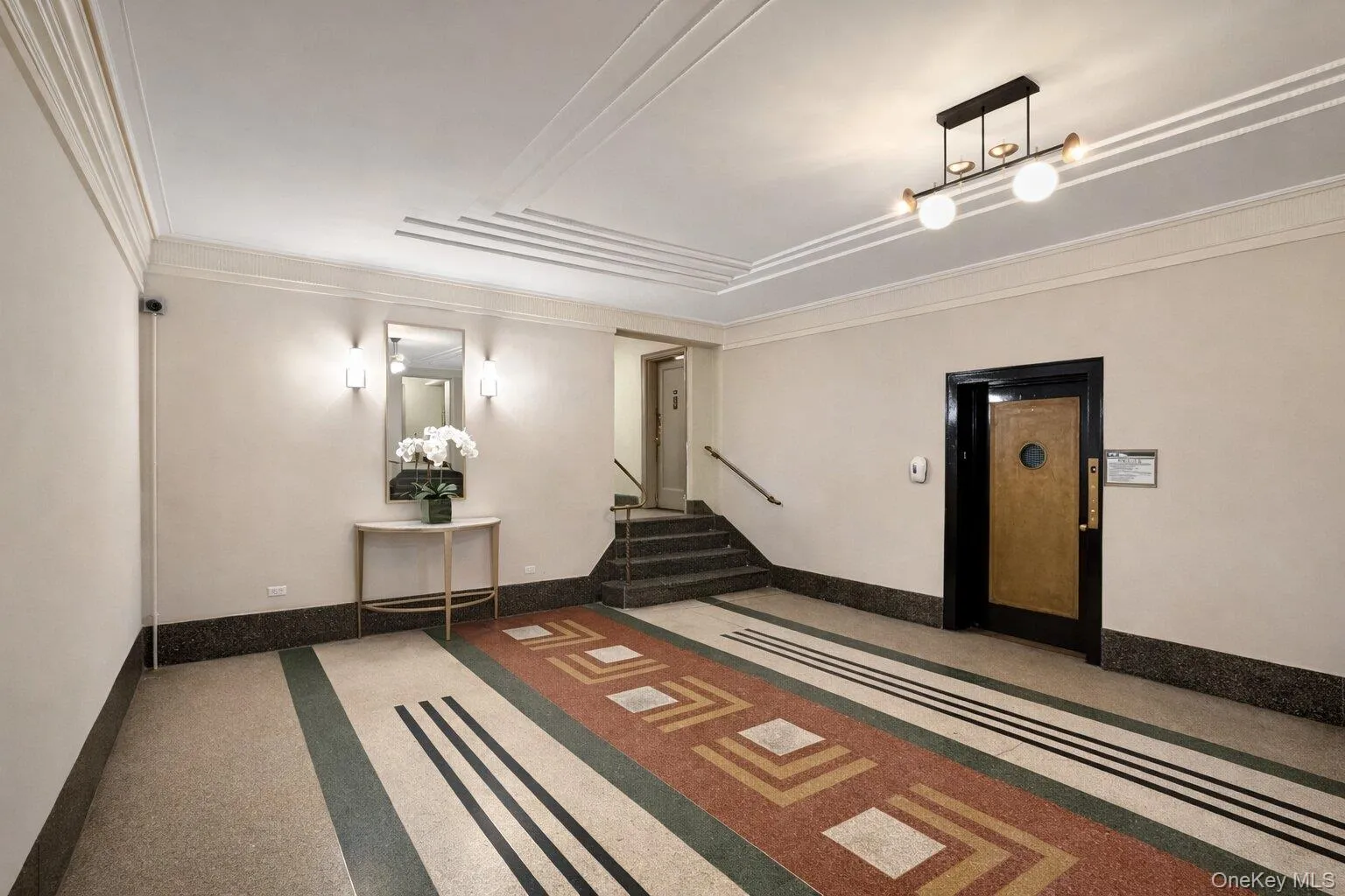 Community lobby featuring stairway and ornamental molding Community lobby featuring stairway and ornamental molding