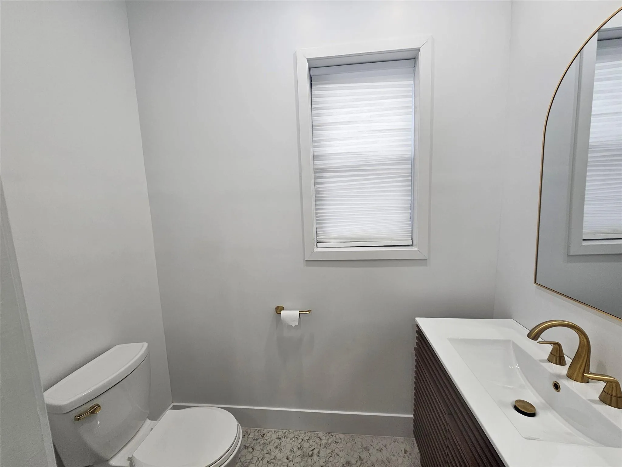 Half bath featuring toilet, baseboards, and vanity Half bath featuring toilet, baseboards, and vanity