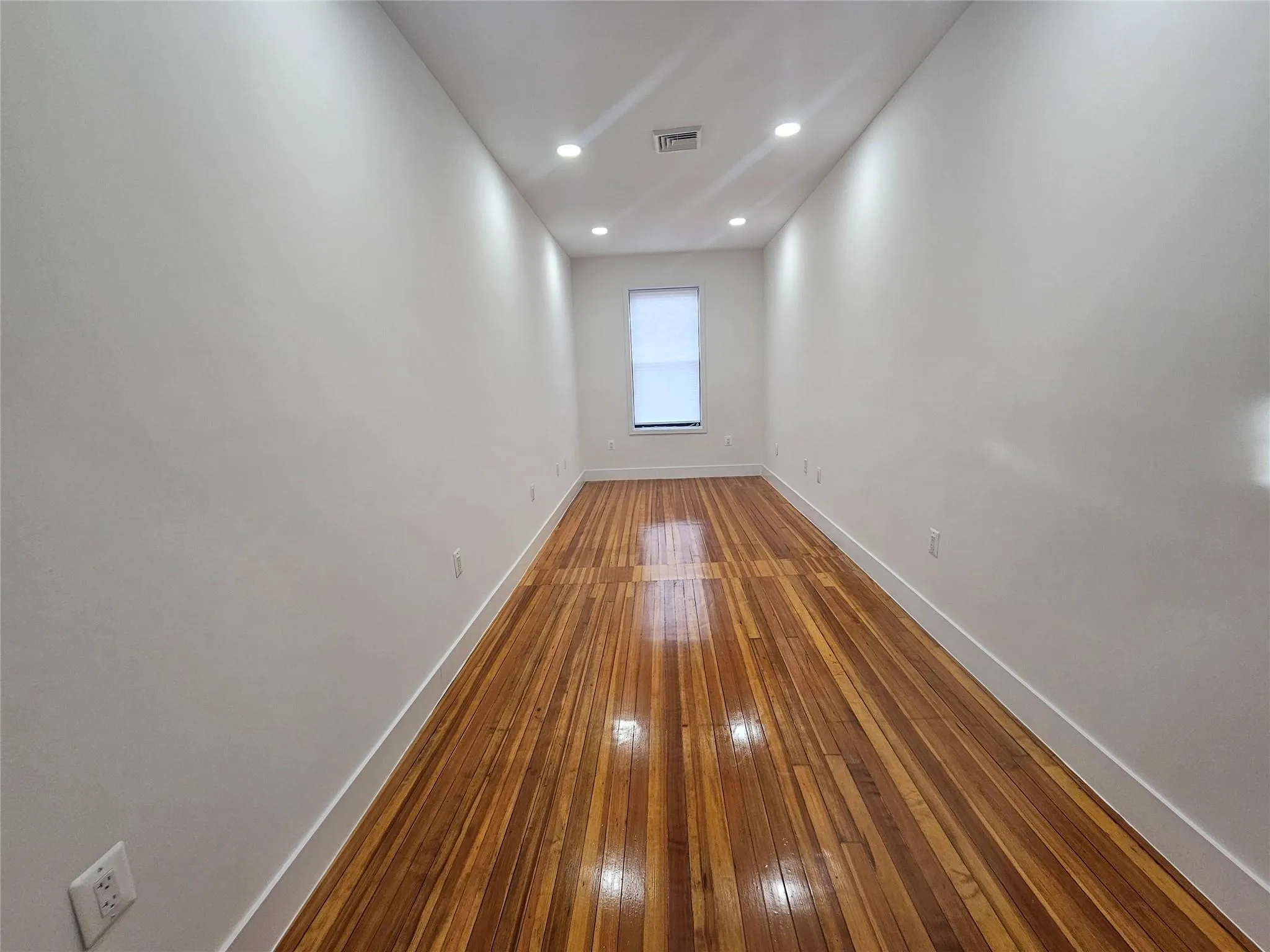 Unfurnished room with baseboards, hardwood / wood-style floors, and recessed lighting Unfurnished room with baseboards, hardwood / wood-style floors, and recessed lighting