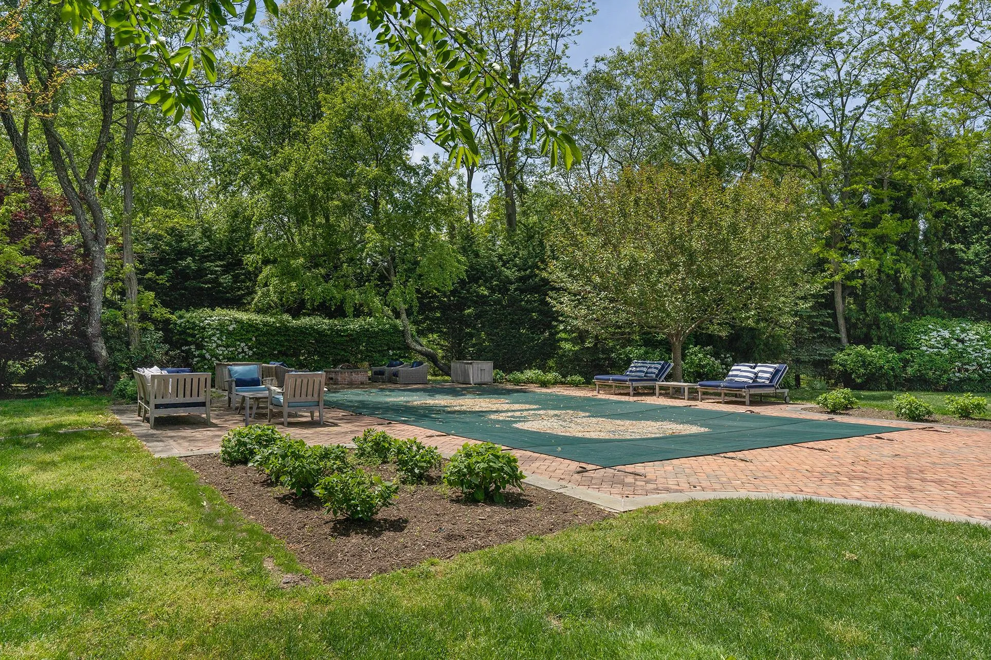 View of pool featuring a patio, a lawn, and a covered pool View of pool featuring a patio, a lawn, and a covered pool