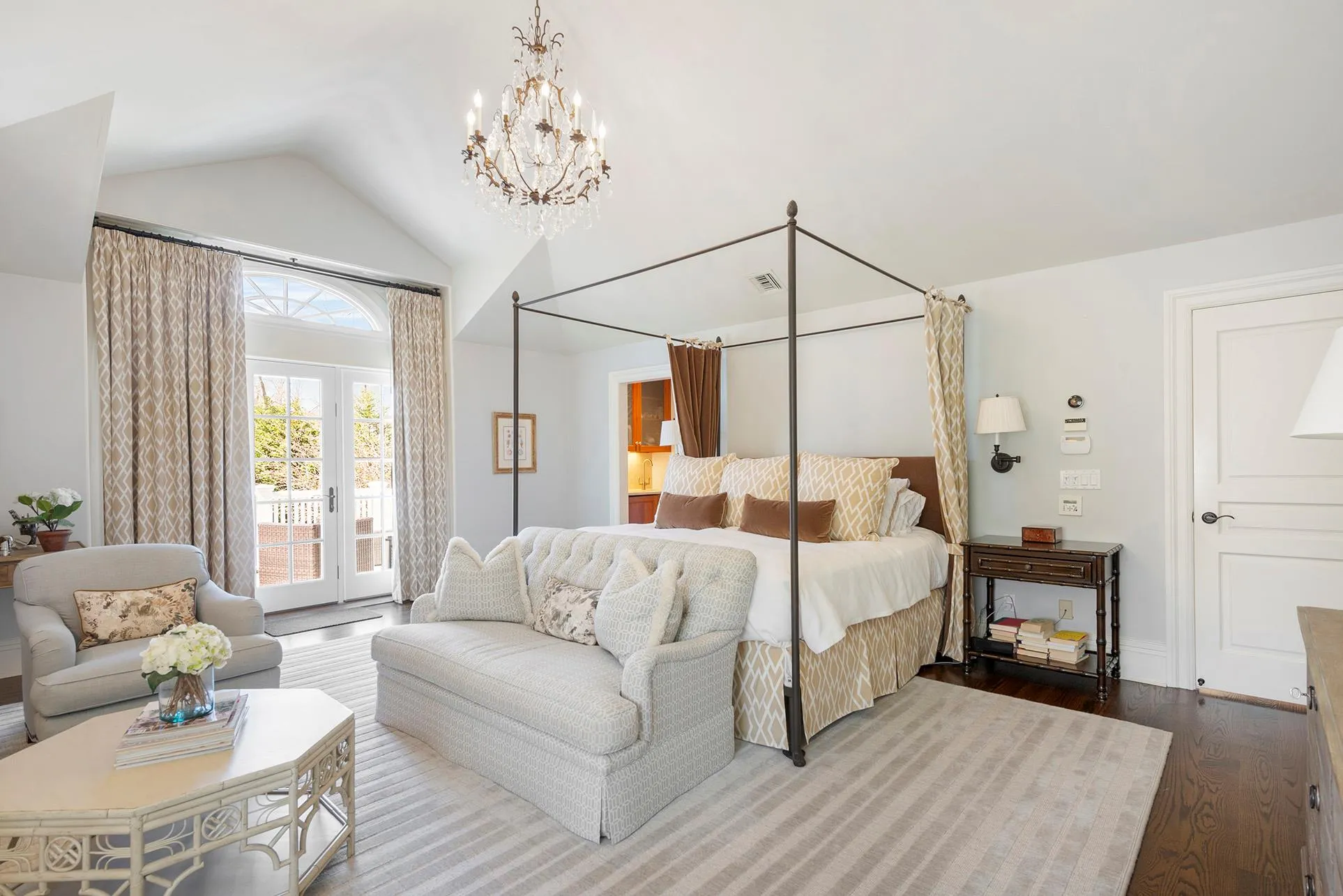 Bedroom featuring access to outside, wood finished floors, lofted ceiling, and a chandelier Bedroom featuring access to outside, wood finished floors, lofted ceiling, and a chandelier