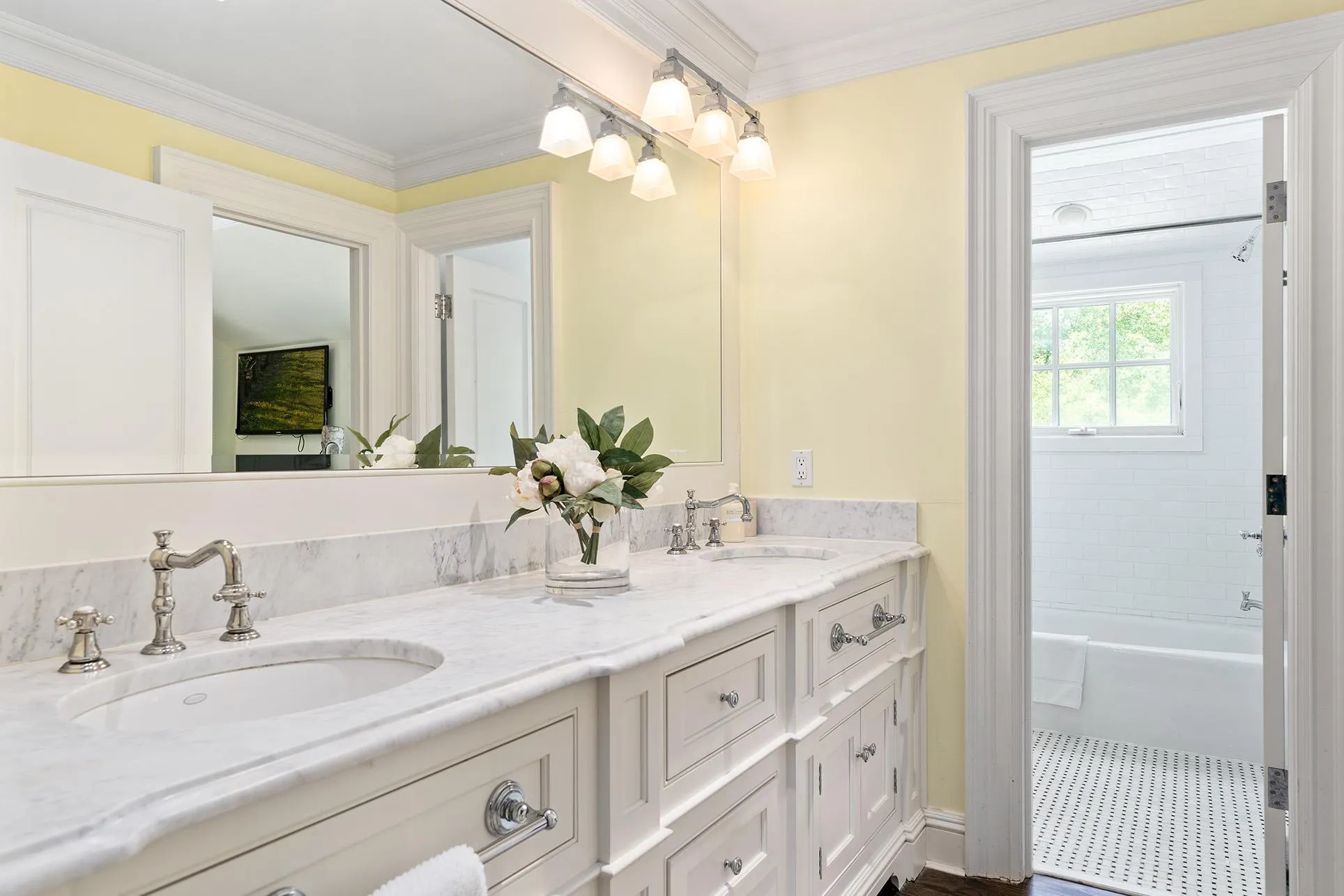 Full bathroom featuring double vanity and ornamental molding Full bathroom featuring double vanity and ornamental molding