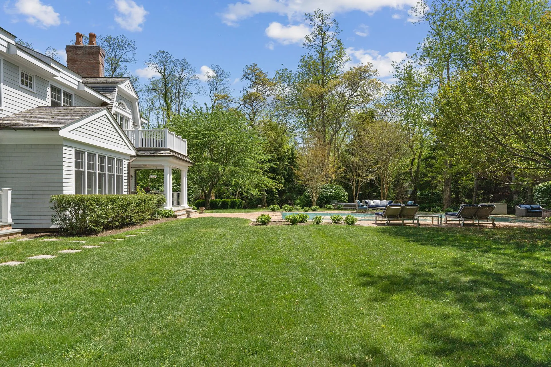 View of green lawn with a balcony View of green lawn with a balcony