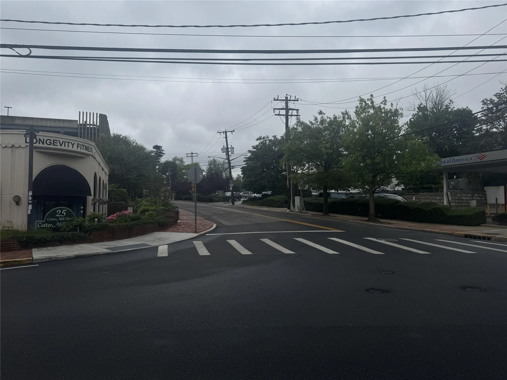 View of asphalt road with sidewalks, traffic signs, and curbs View of asphalt road with sidewalks, traffic signs, and curbs