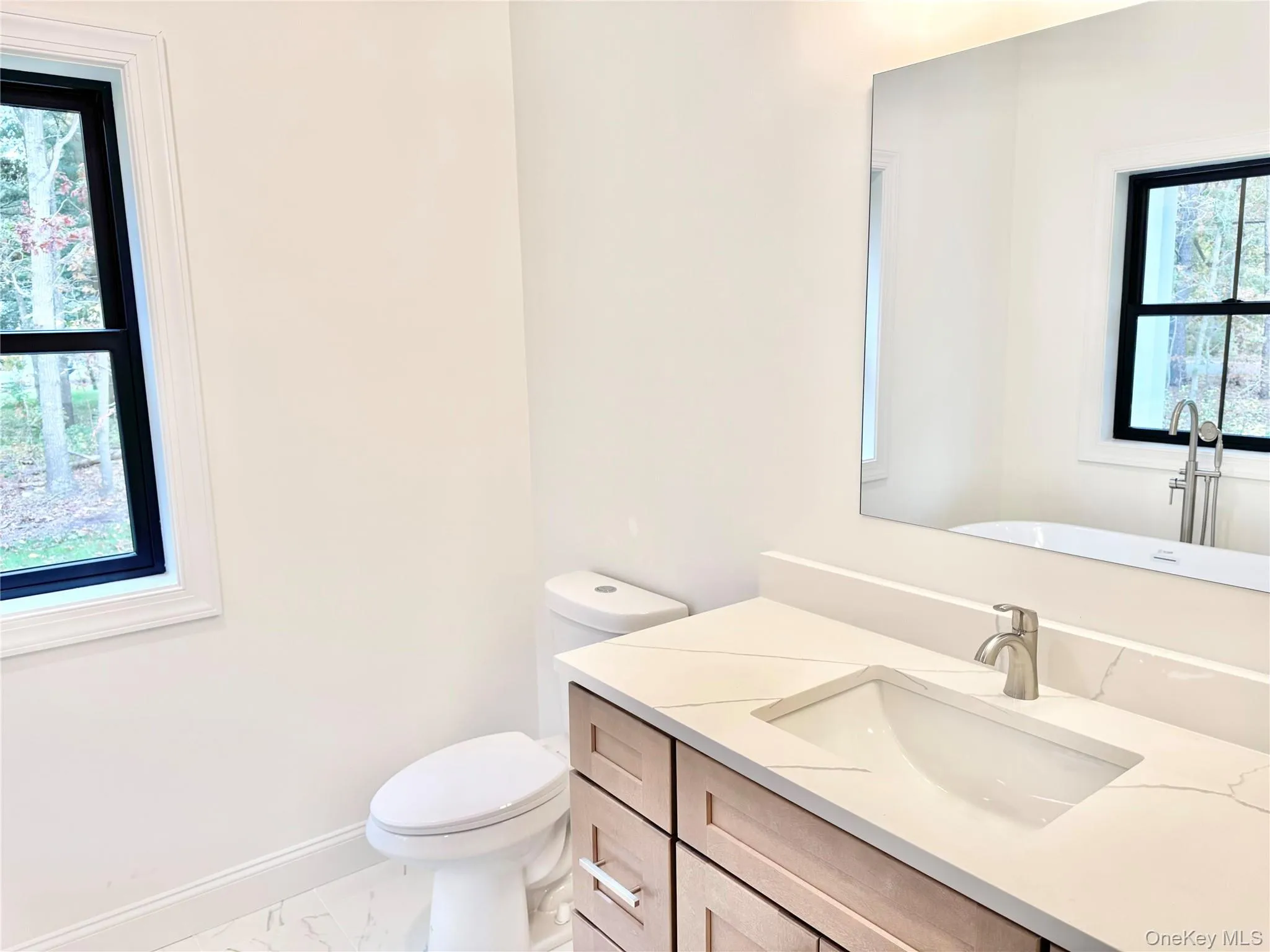 Bathroom with vanity and marble finish flooring Bathroom with vanity and marble finish flooring