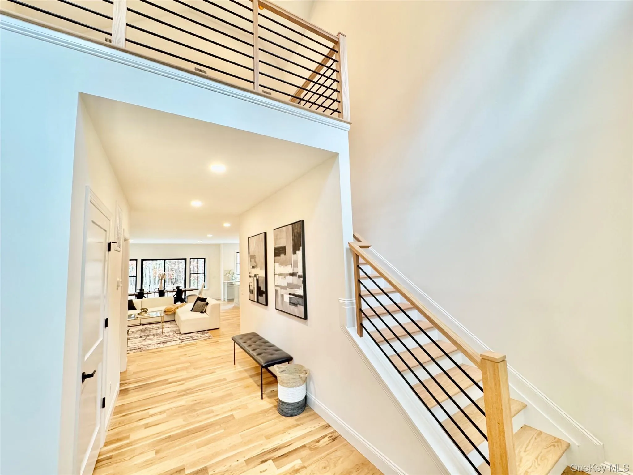 Hall with light wood finished floors and recessed lighting Hall with light wood finished floors and recessed lighting