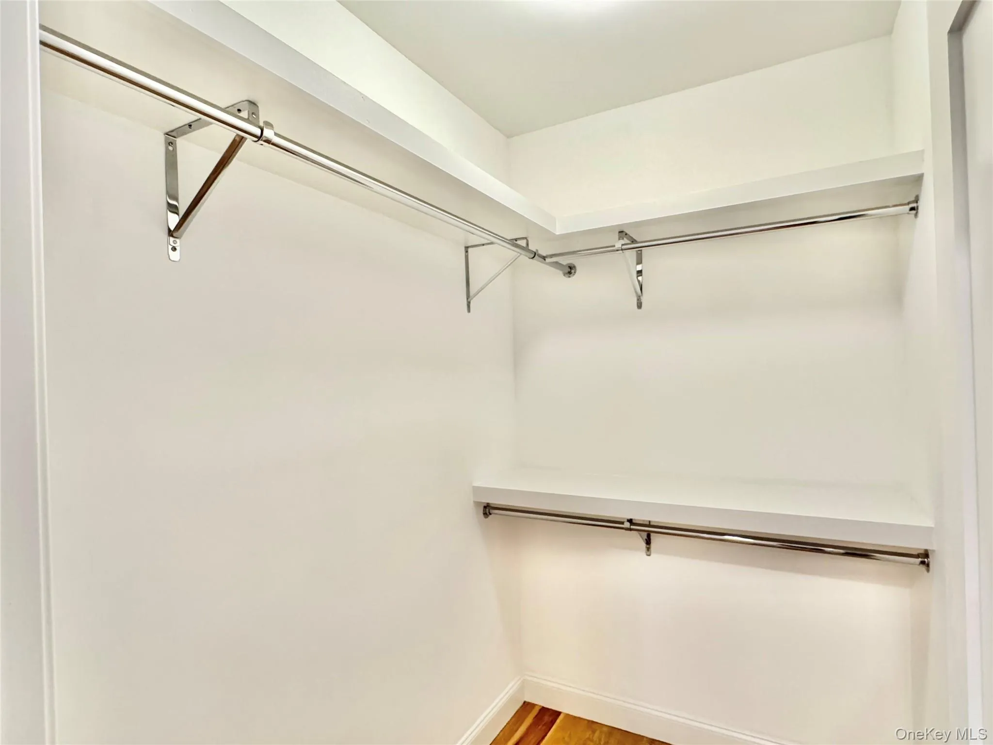 Spacious closet with light wood finished floors Spacious closet with light wood finished floors