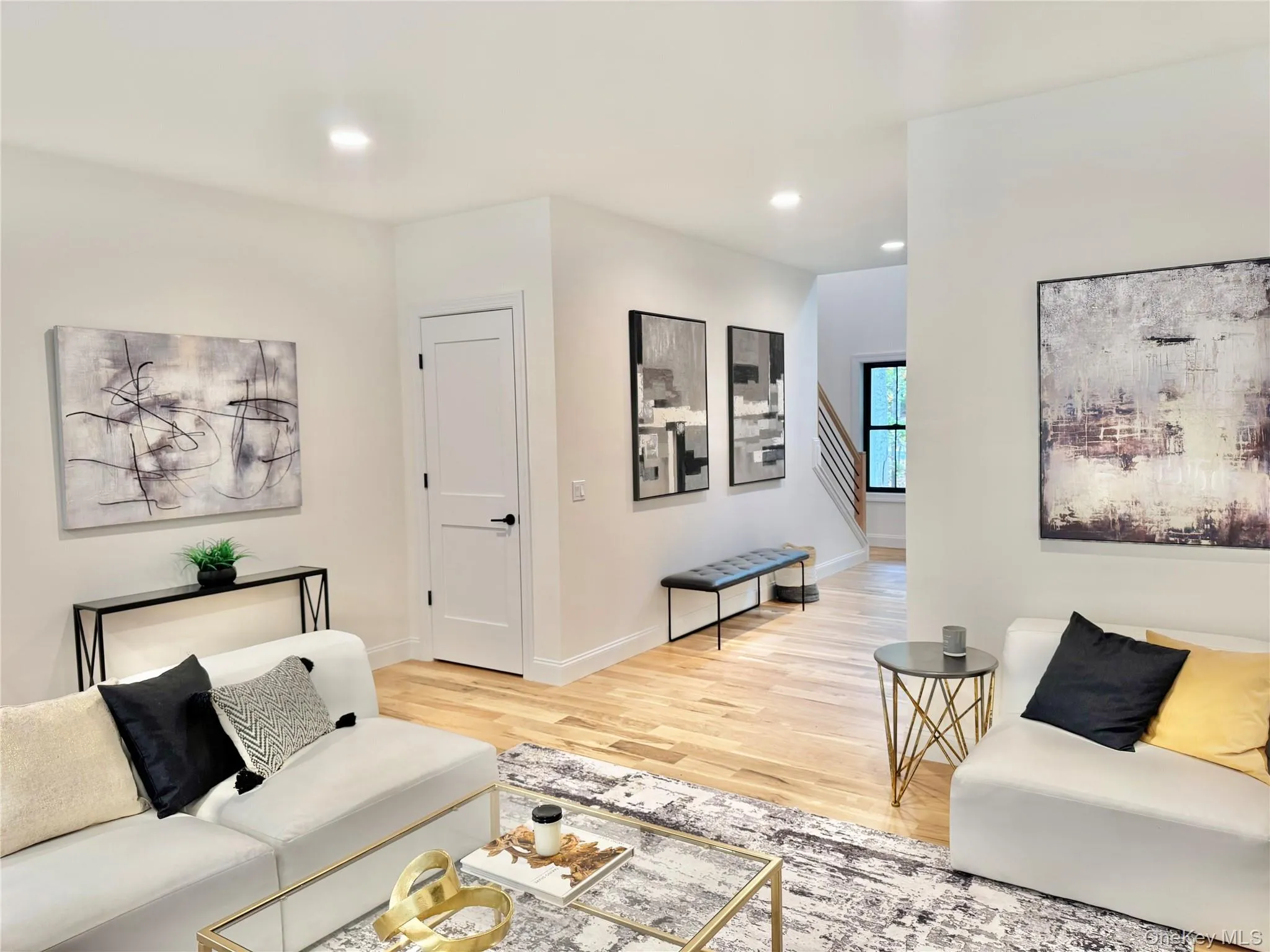 Living area featuring light wood-style flooring and recessed lighting Living area featuring light wood-style flooring and recessed lighting