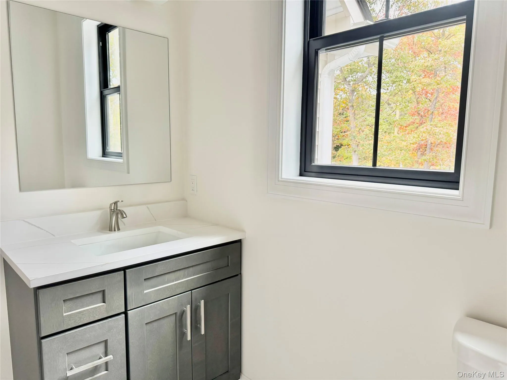 Bathroom featuring vanity and healthy amount of natural light Bathroom featuring vanity and healthy amount of natural light