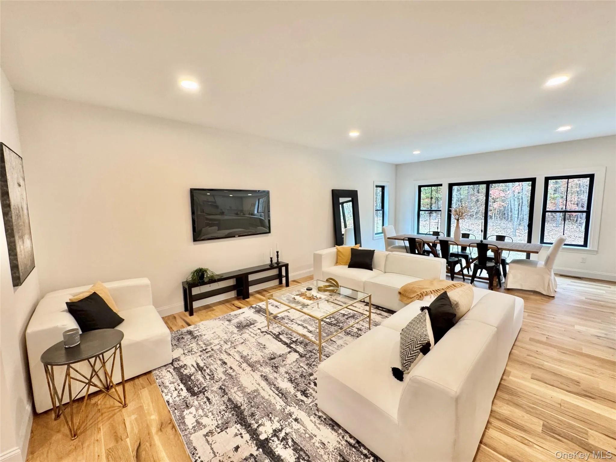 Living room with light wood-style flooring and recessed lighting Living room with light wood-style flooring and recessed lighting