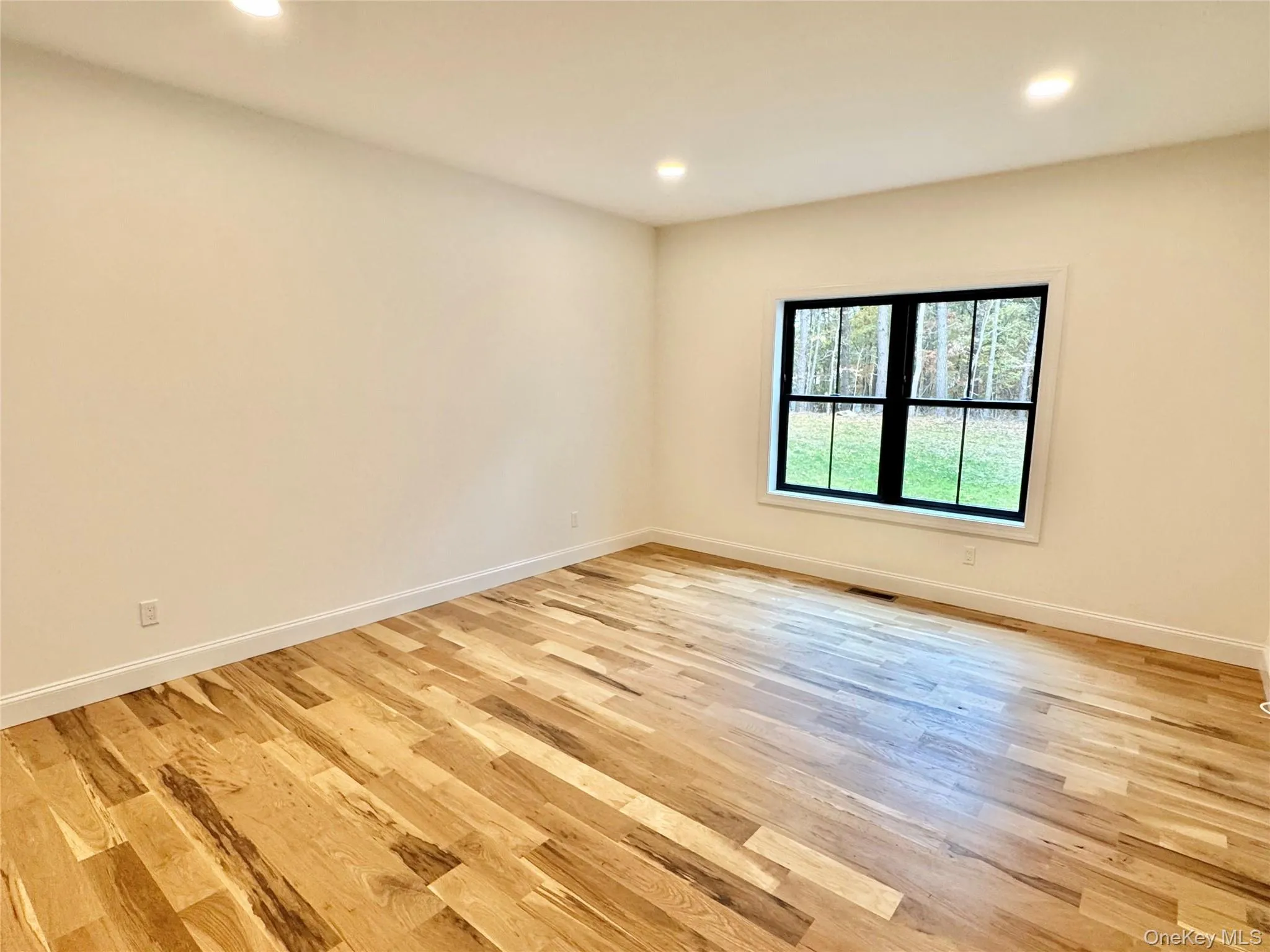Empty room with recessed lighting and light wood-style flooring Empty room with recessed lighting and light wood-style flooring