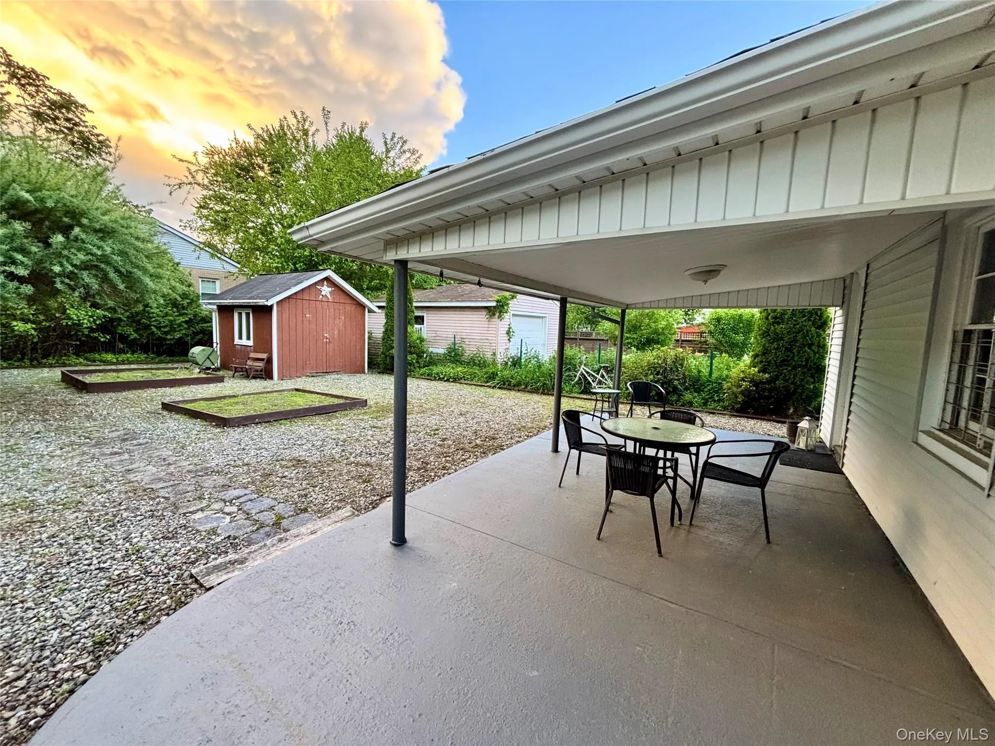 Patio terrace at dusk with a patio area and outdoor dining space Patio terrace at dusk with a patio area and outdoor dining space
