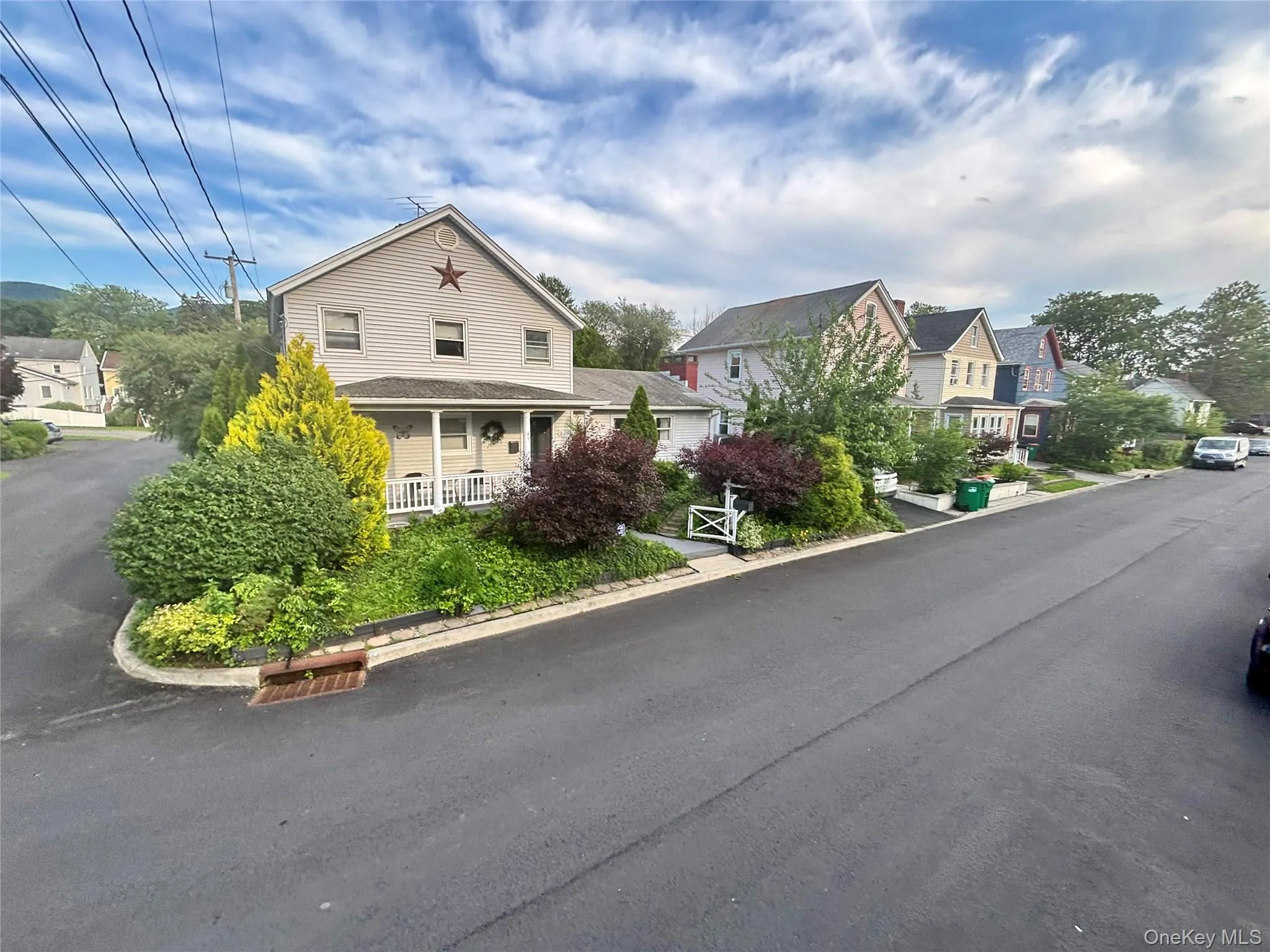 View of asphalt street with a residential view and curbs View of asphalt street with a residential view and curbs