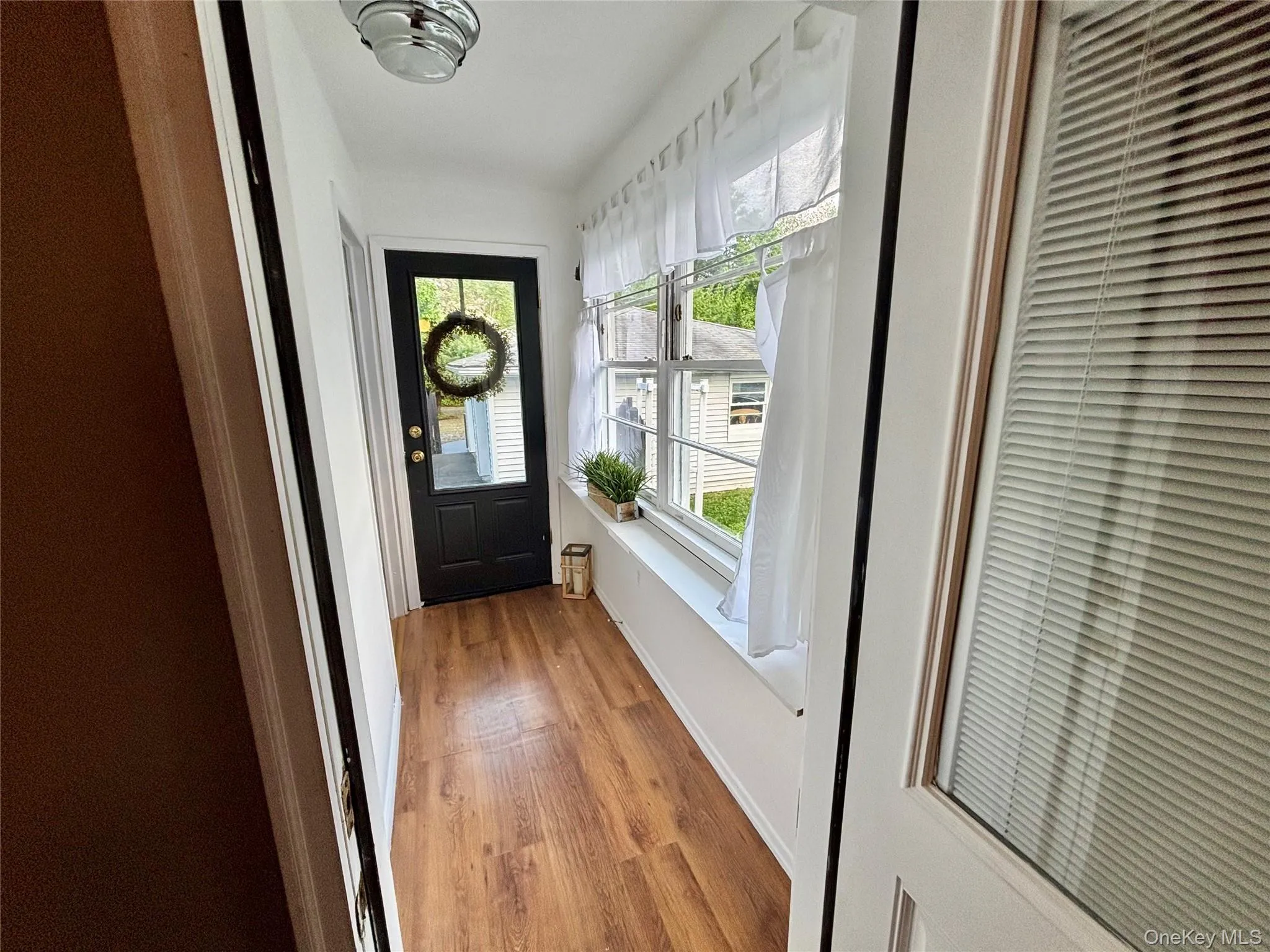 Entryway with light wood-style floors, a heating unit, and baseboards Entryway with light wood-style floors, a heating unit, and baseboards
