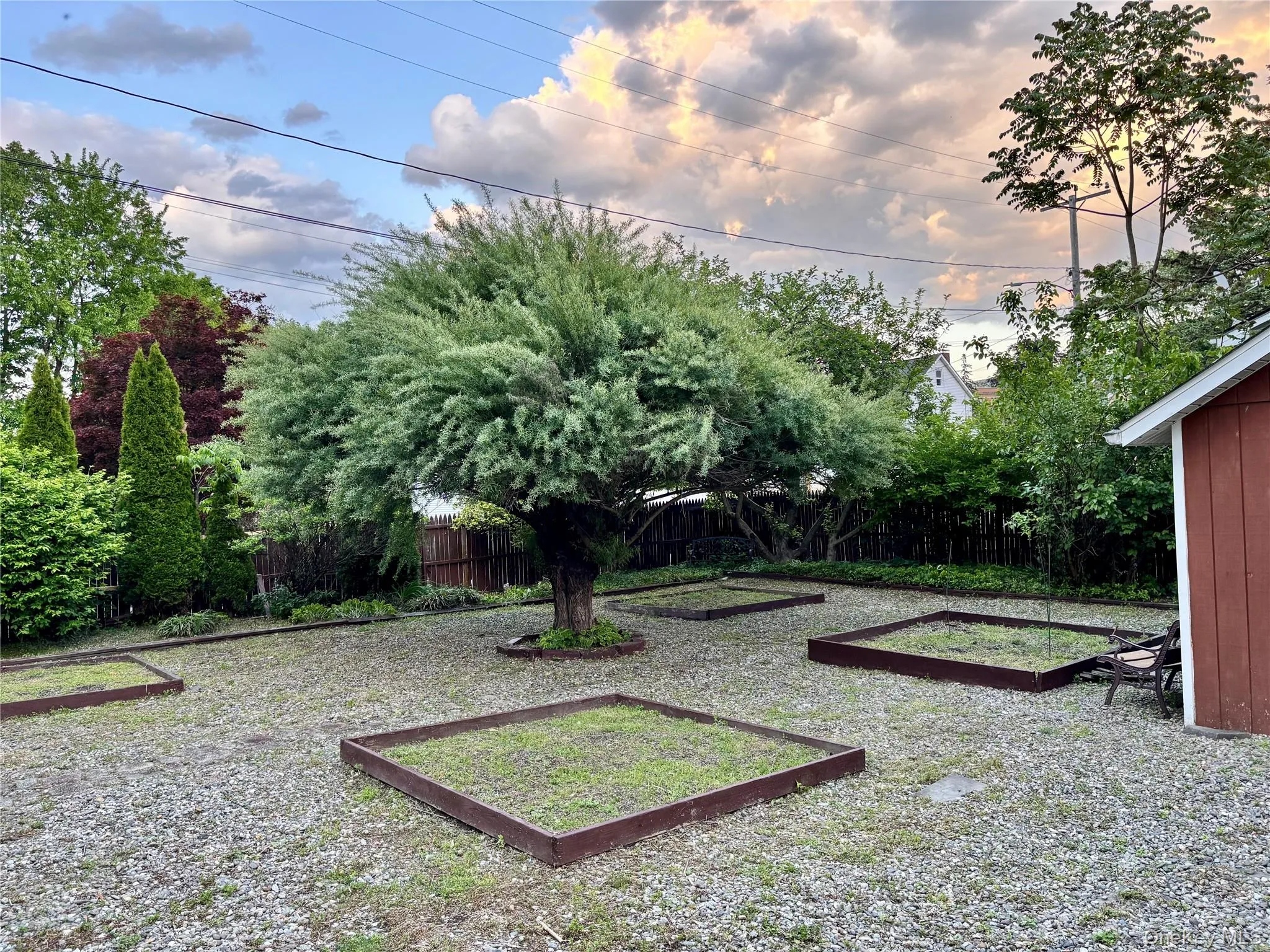 Fenced backyard with a vegetable garden Fenced backyard with a vegetable garden
