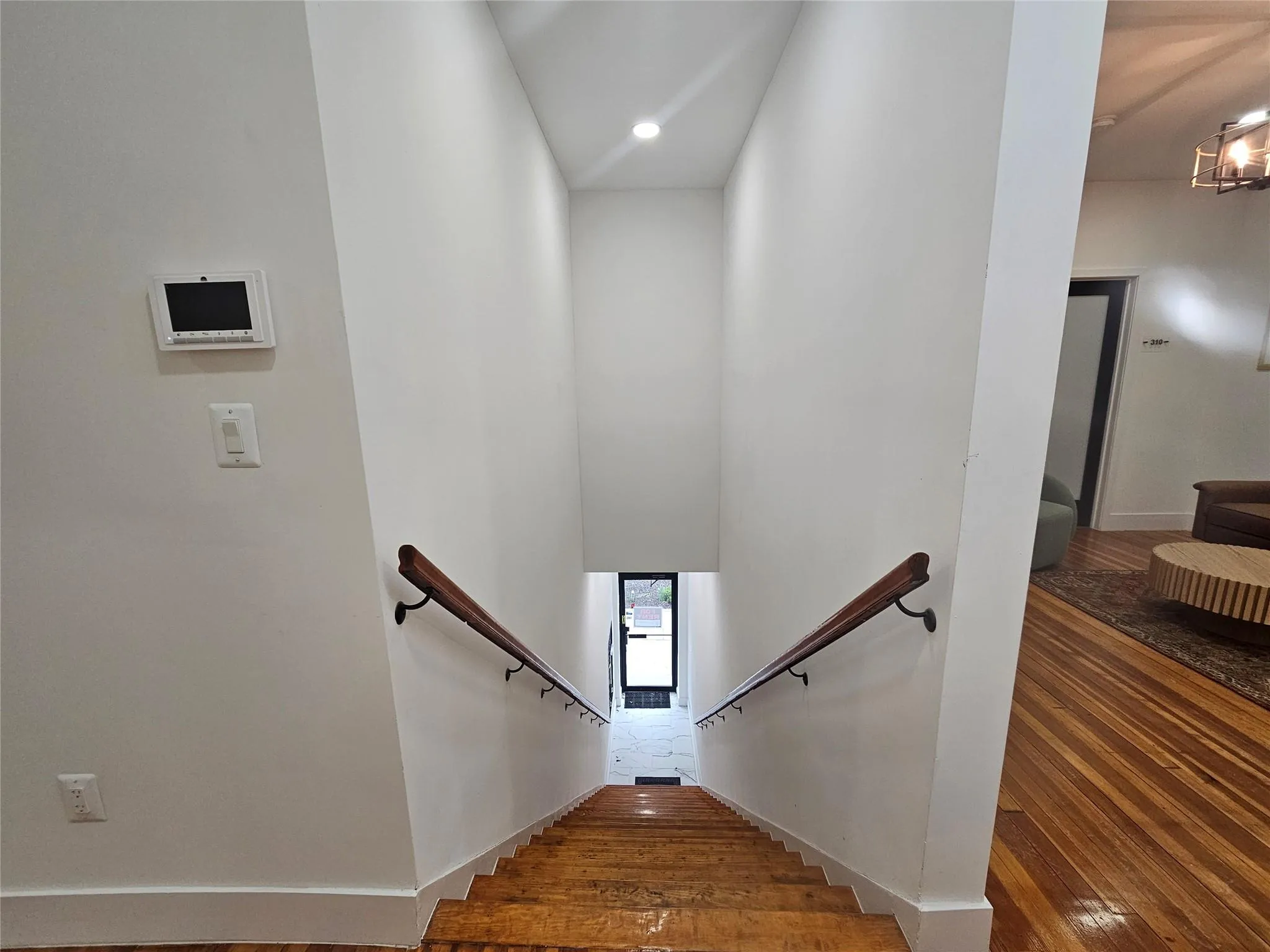 Stairway featuring wood-type flooring, recessed lighting, and baseboards Stairway featuring wood-type flooring, recessed lighting, and baseboards