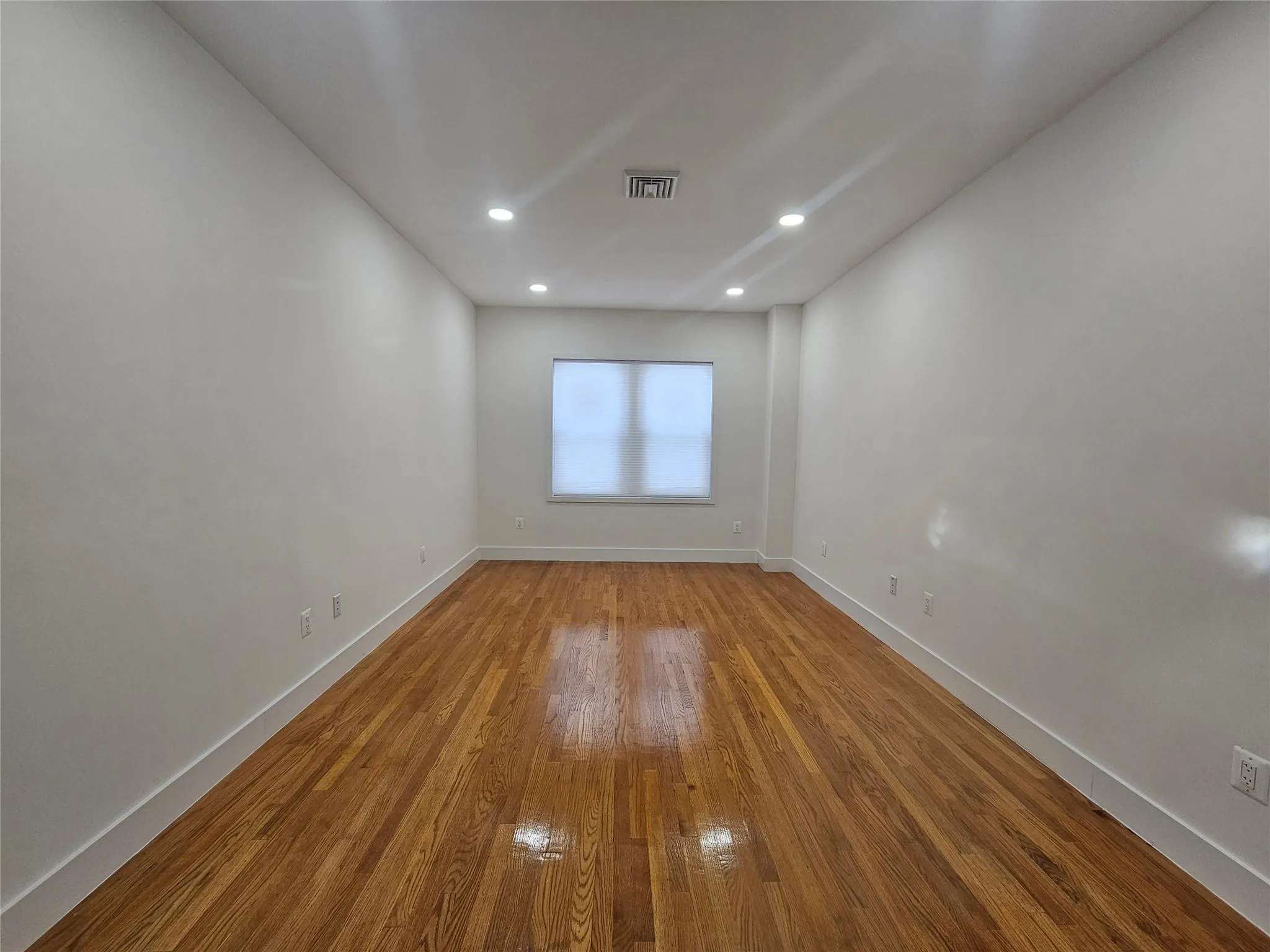 Spare room featuring baseboards, wood finished floors, and recessed lighting Spare room featuring baseboards, wood finished floors, and recessed lighting