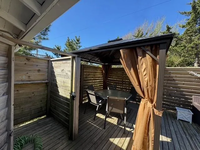 Deck with outdoor dining space and a gazebo Deck with outdoor dining space and a gazebo