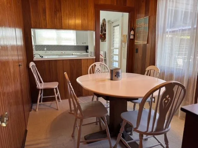 Dining room featuring wooden walls Dining room featuring wooden walls