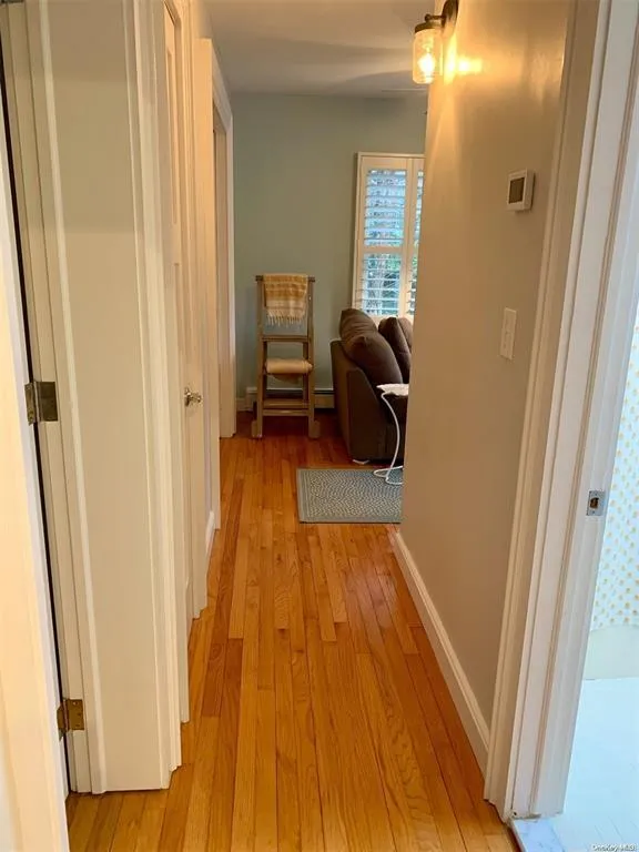 Corridor with light wood finished floors and baseboards Corridor with light wood finished floors and baseboards