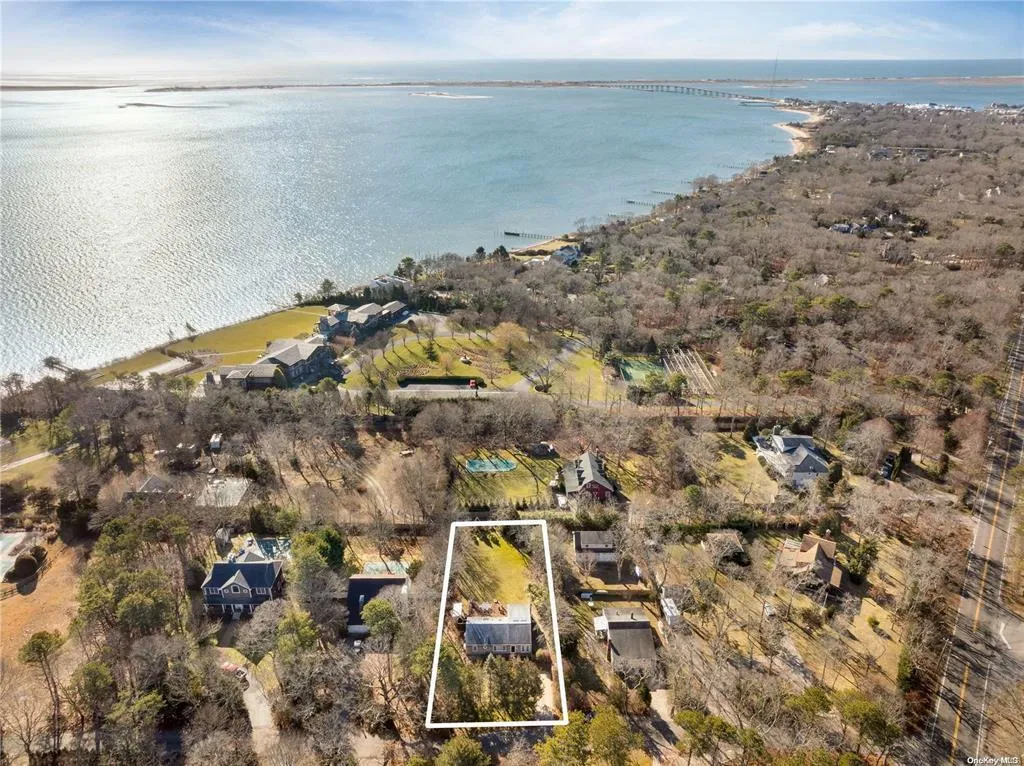 Aerial view of property's location with a large body of water and property parcel outlined Aerial view of property's location with a large body of water and property parcel outlined